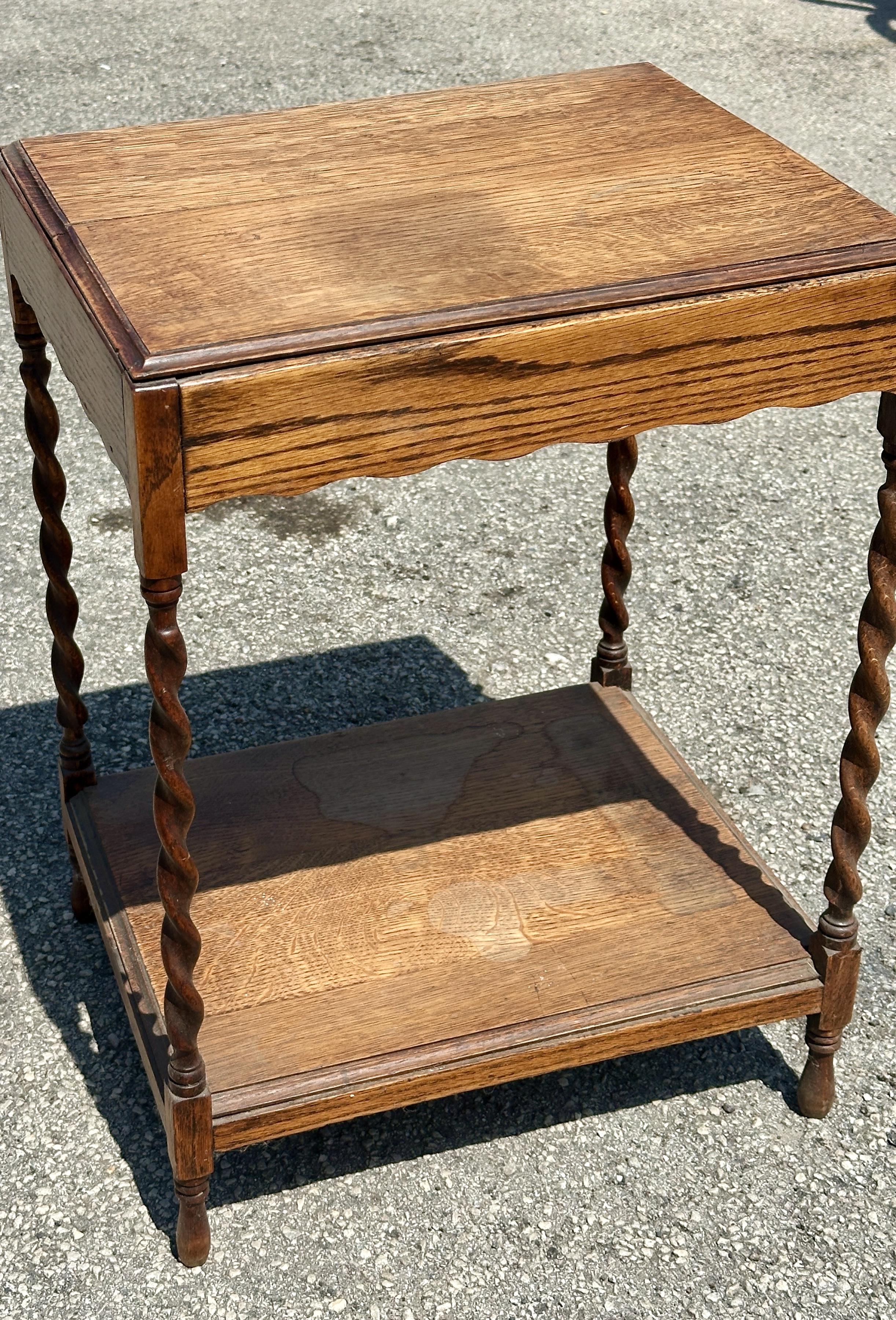 An early 20th-century Jacobean Revival oak two-tier side table
