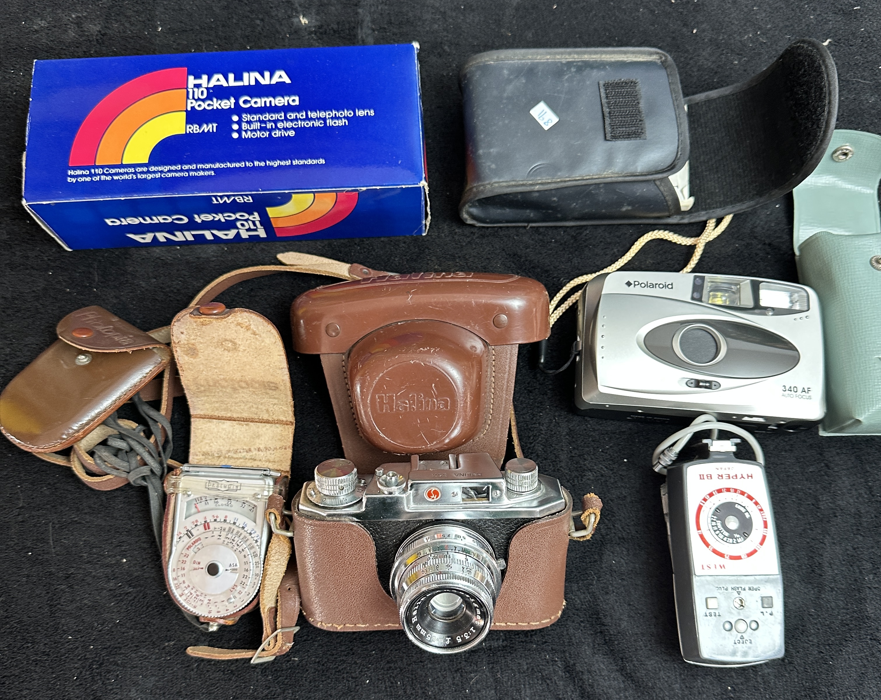 A Collection of Vintage Cameras and Photographic Accessories Including Halina and Polaroid Models