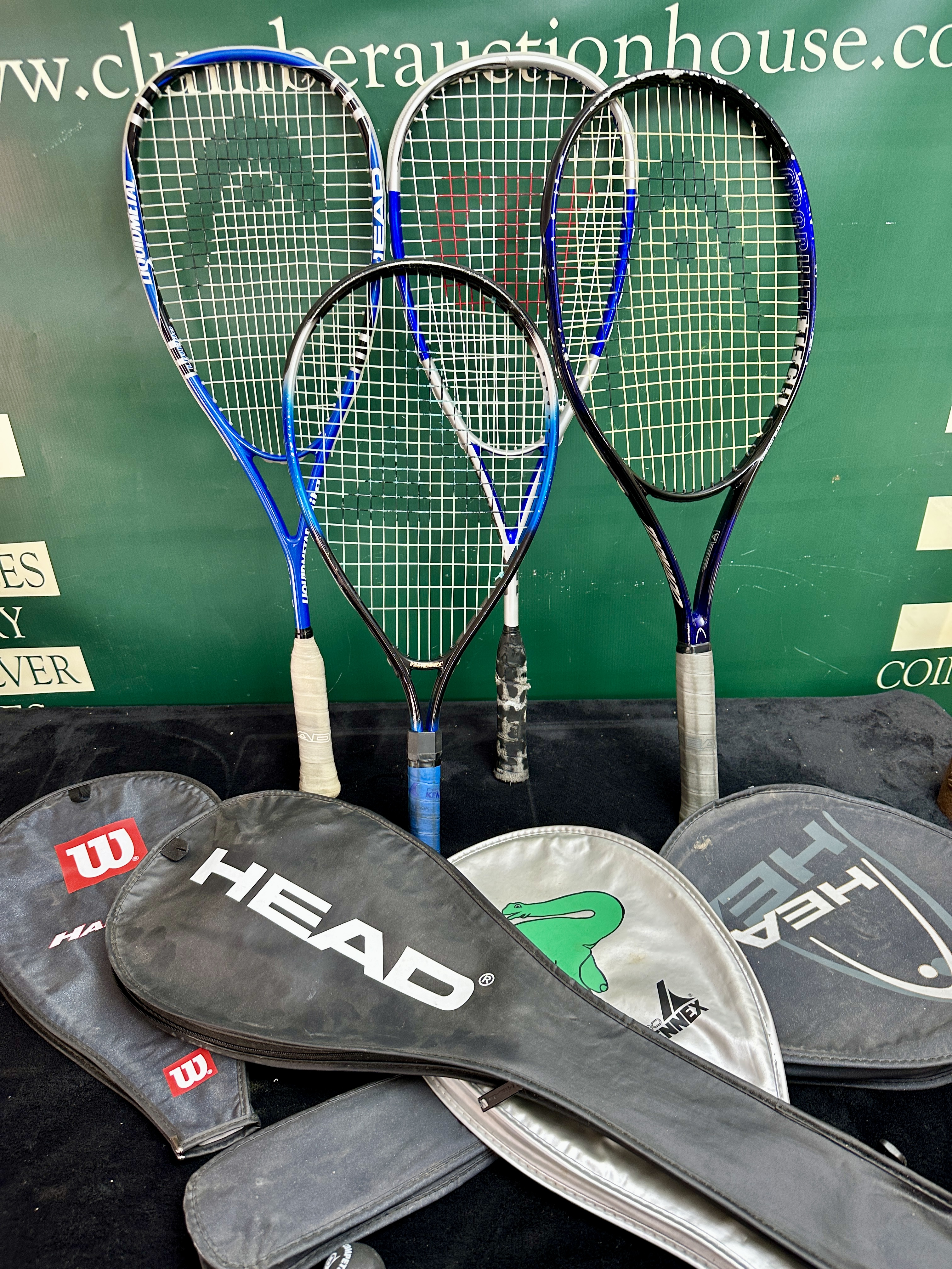 An Assortment of Racquetball Racquets and Branded Padded Covers Including Head and ProKennex Models