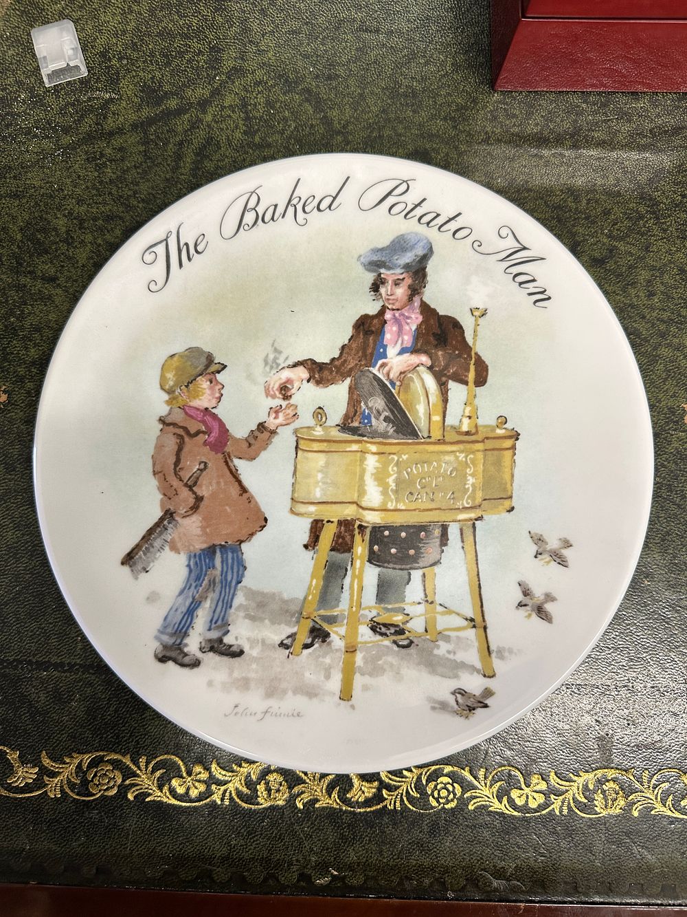 Lot 291: A Wedgwood fine bone china collector's plate, 'The Baked Potato Man' by John Finnie, 1985