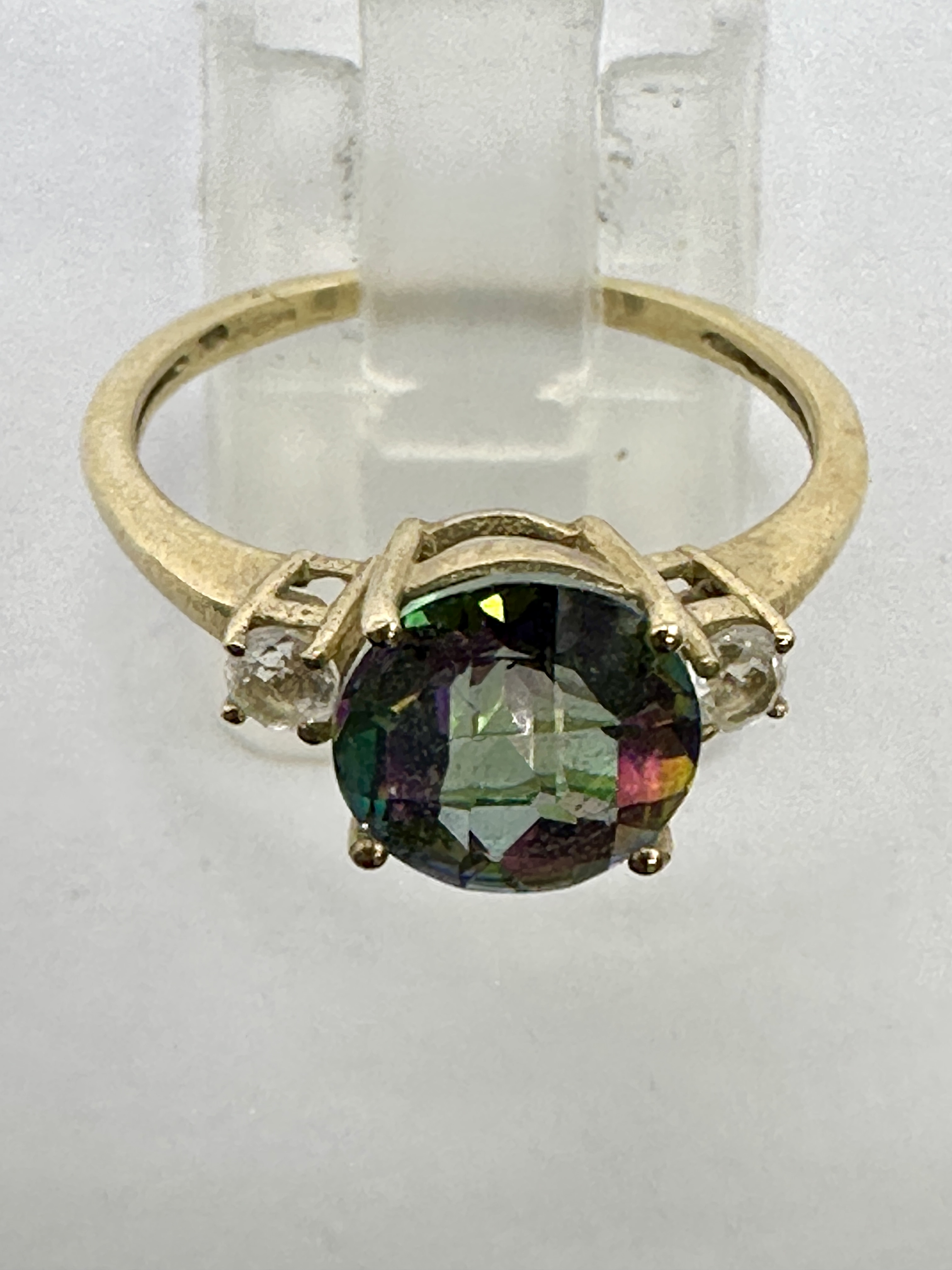 A 9 carat yellow gold and mystic topaz three-stone ring