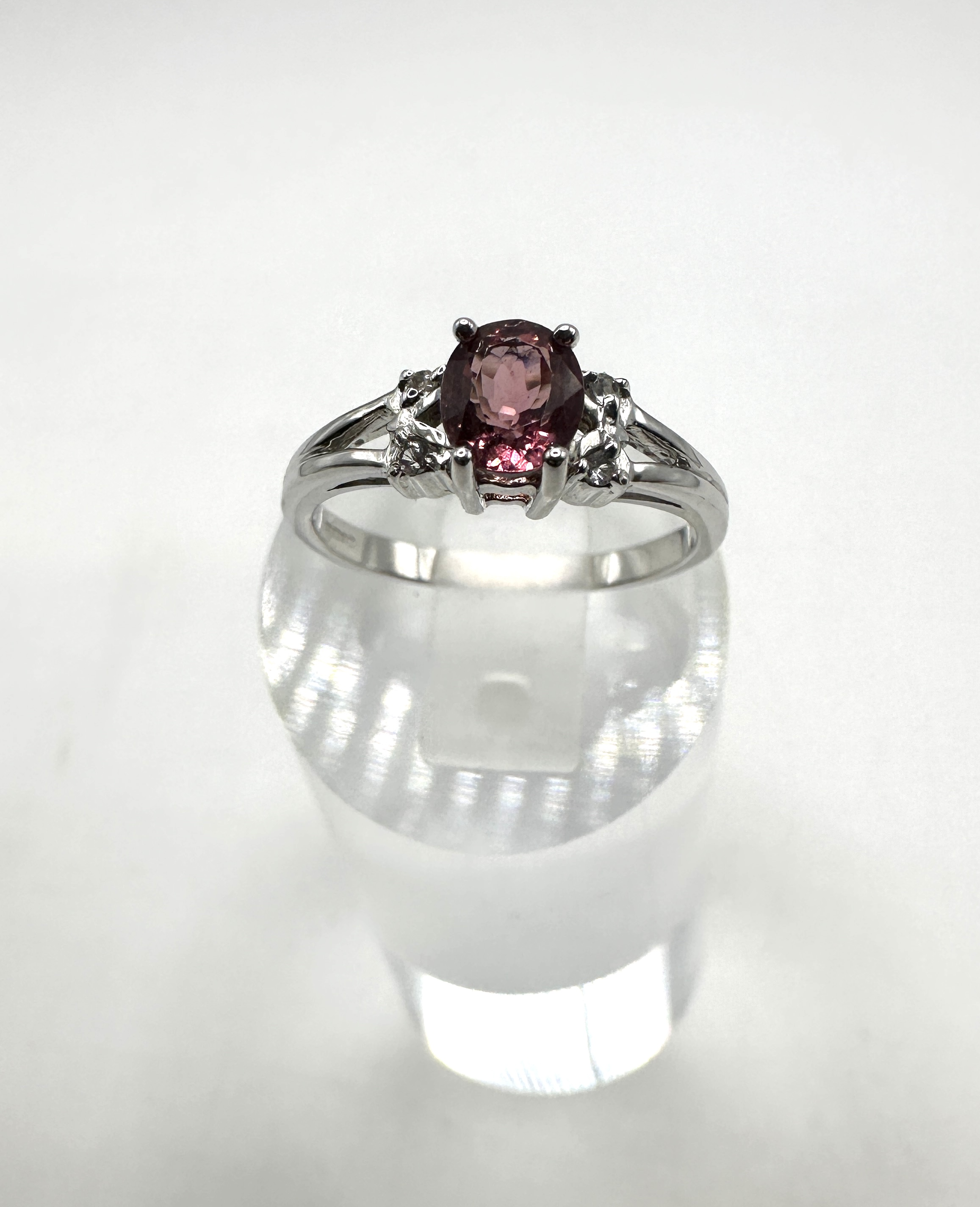 A 9 Carat White Gold, Pinkish-Purple Gemstone and Colourless Stone Dress Ring