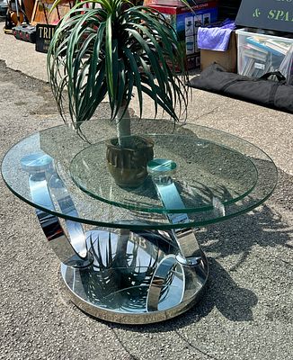A Contemporary Swivelling Chrome and Glass Coffee Table. A contemporary coffee table featuring a 