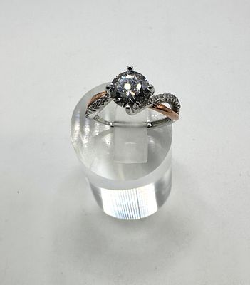 A 925 Silver Two-Tone Twisted Bypass Ring with a Round Brilliant Cut Stone. A contemporary dress 