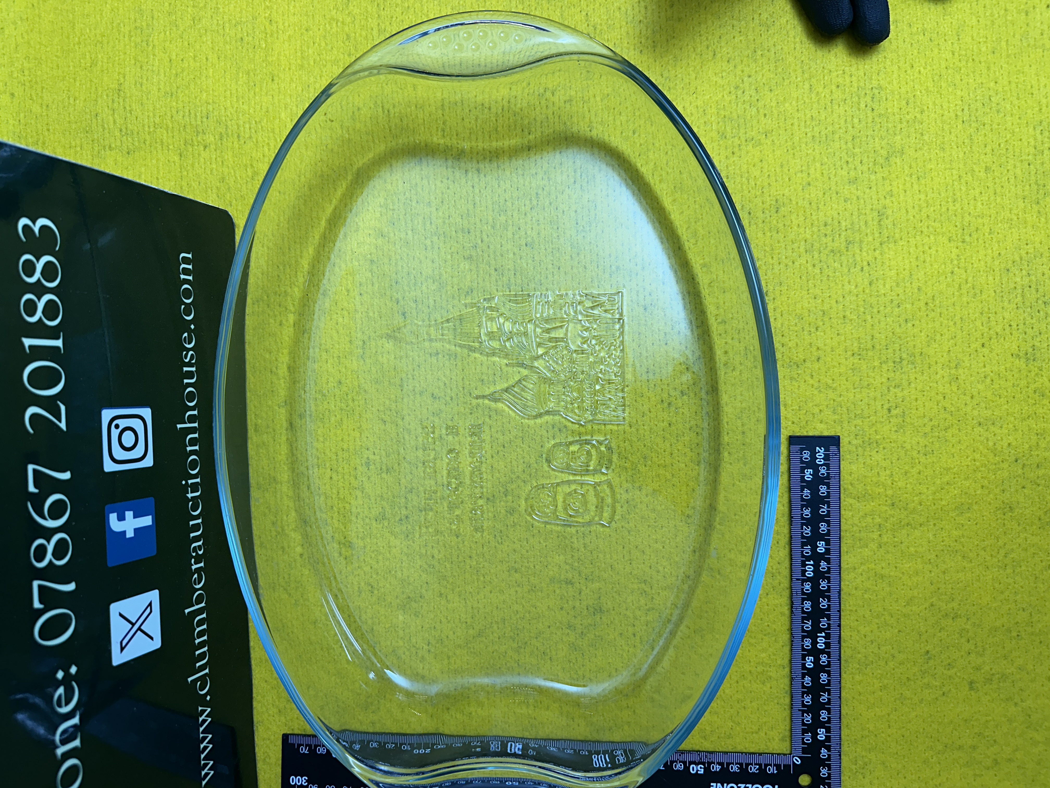 A Vintage Clear Glass Oval Ovenware Dish with Embossed Russian Icons and Cyrillic Text