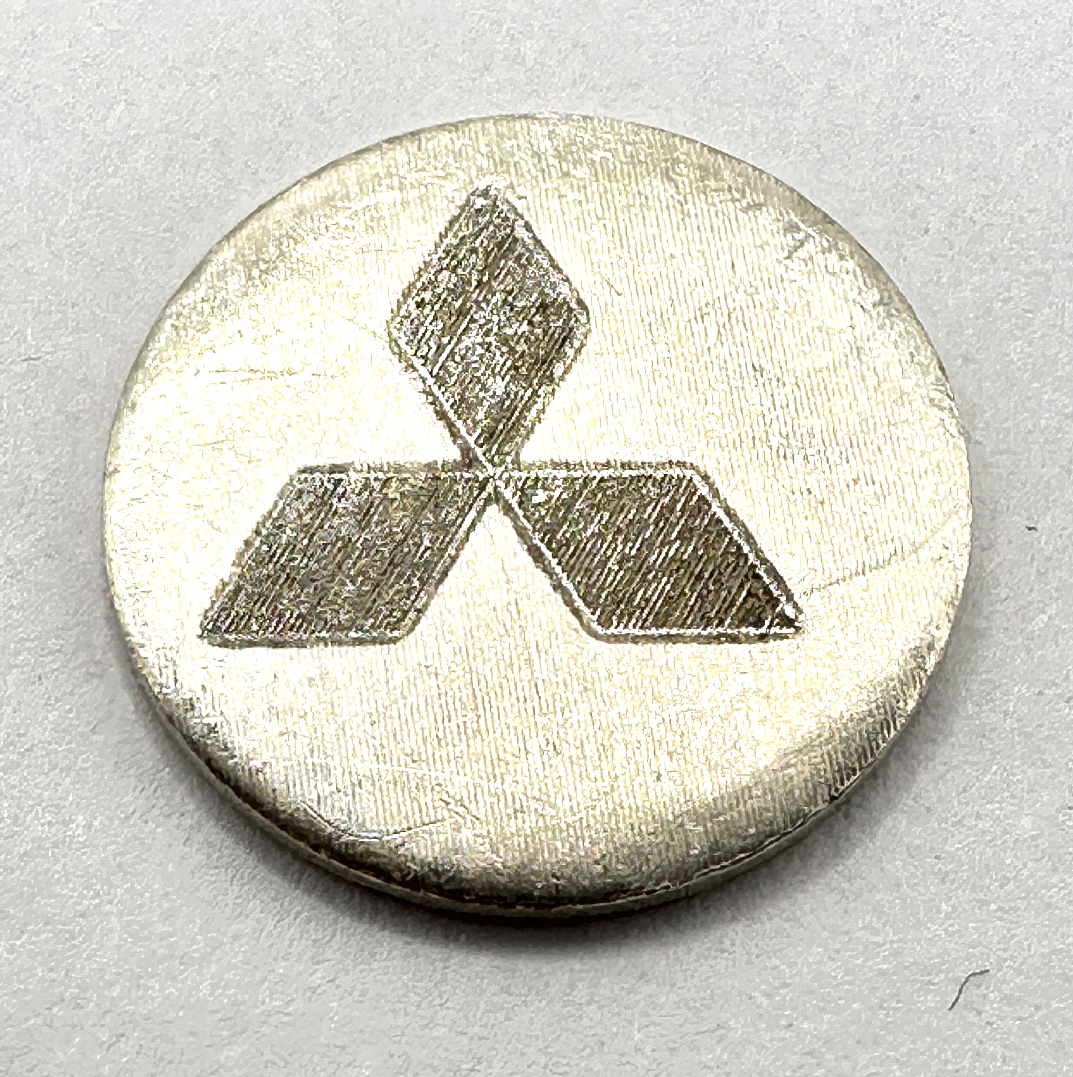 A Mitsubishi Logo 1 Gram .999 Fine Silver Bullion Round