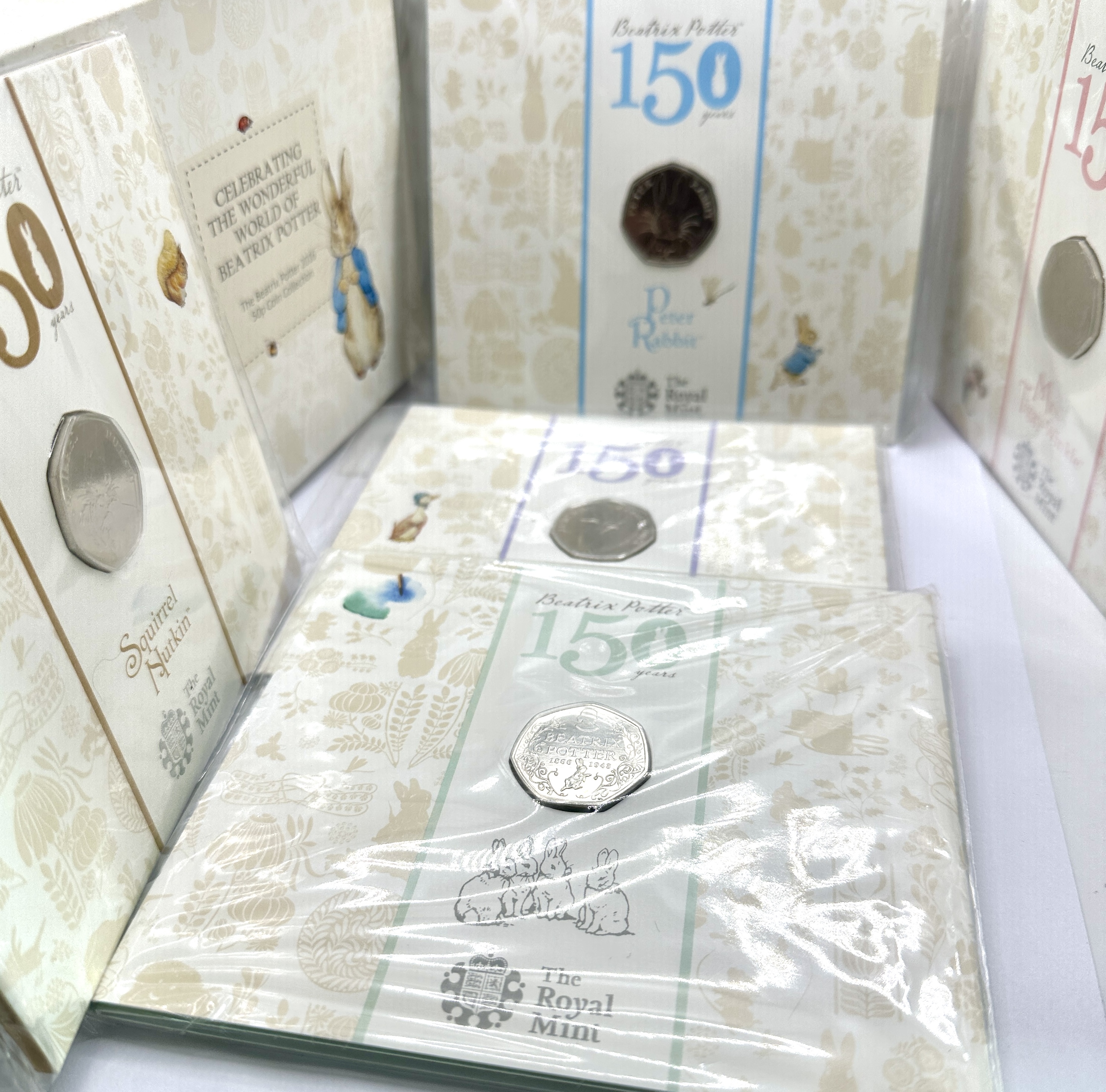 A Collection of UK 2016 The Royal Mint Beatrix Potter 150th Anniversary Brilliant Uncirculated 50 Pence Coins