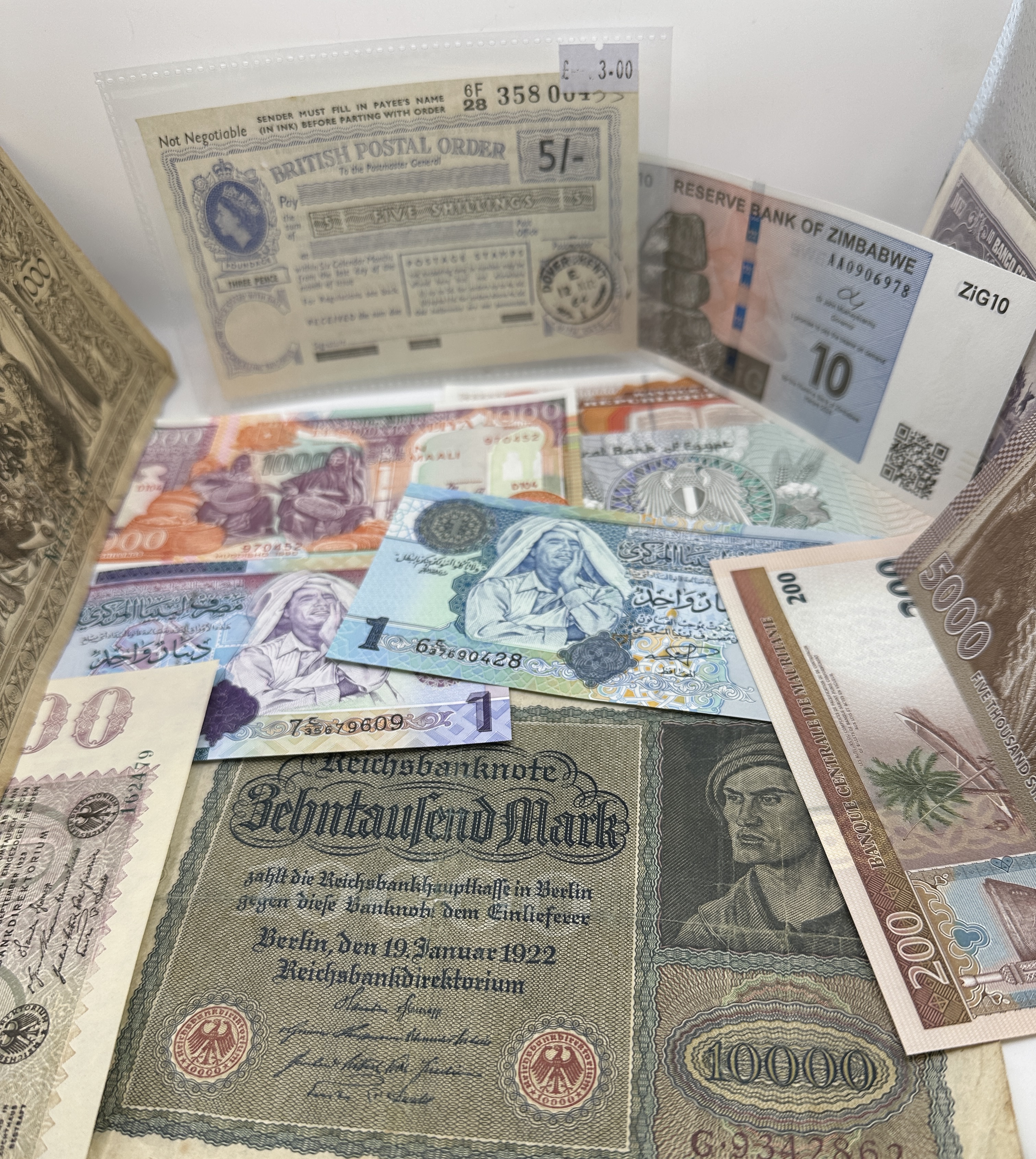 A Collection of International Banknotes and Ephemera Including Weimar Republic Hyperinflationary Notes and a British Postal Order