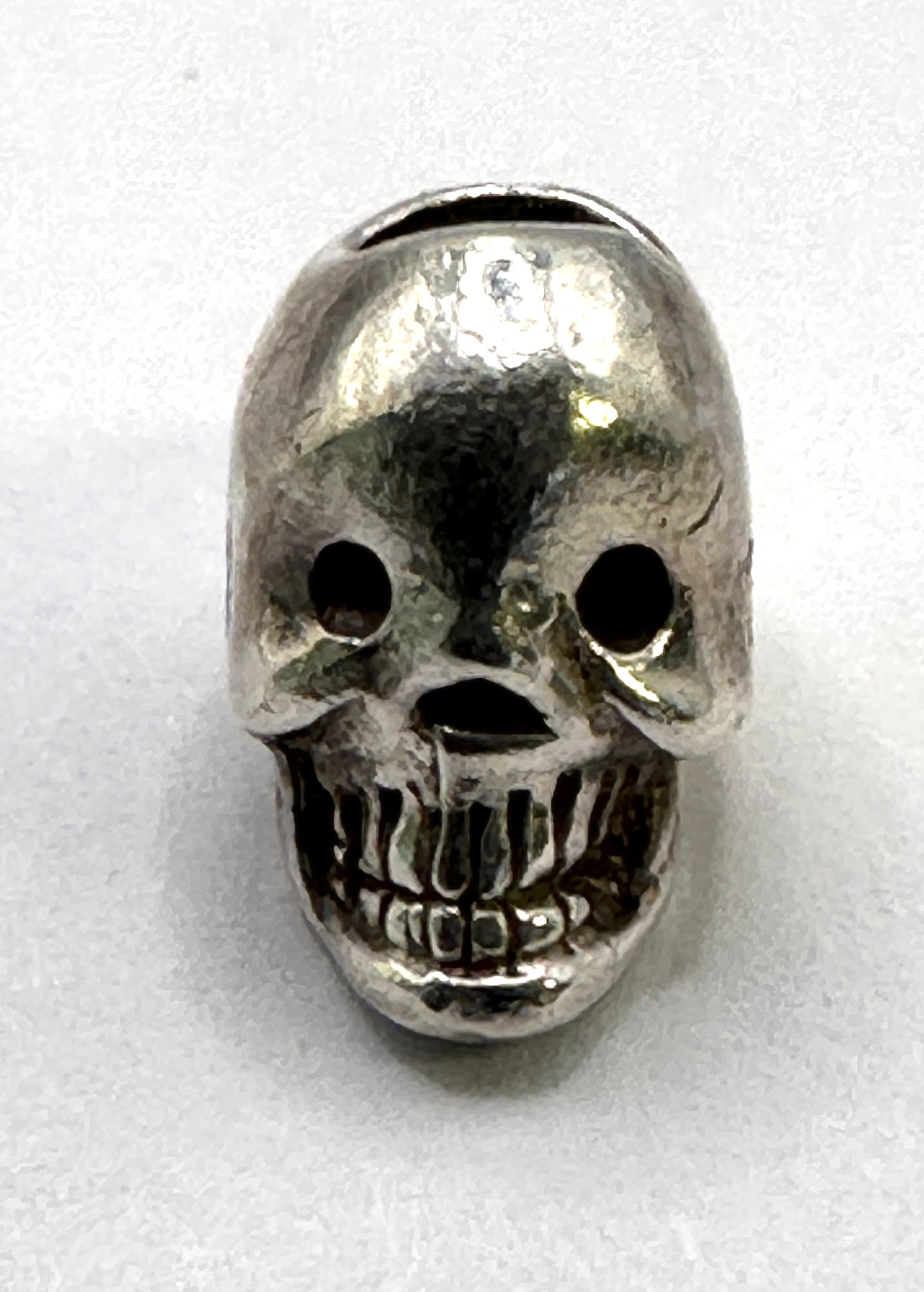 A Silver Skull Bead Charm