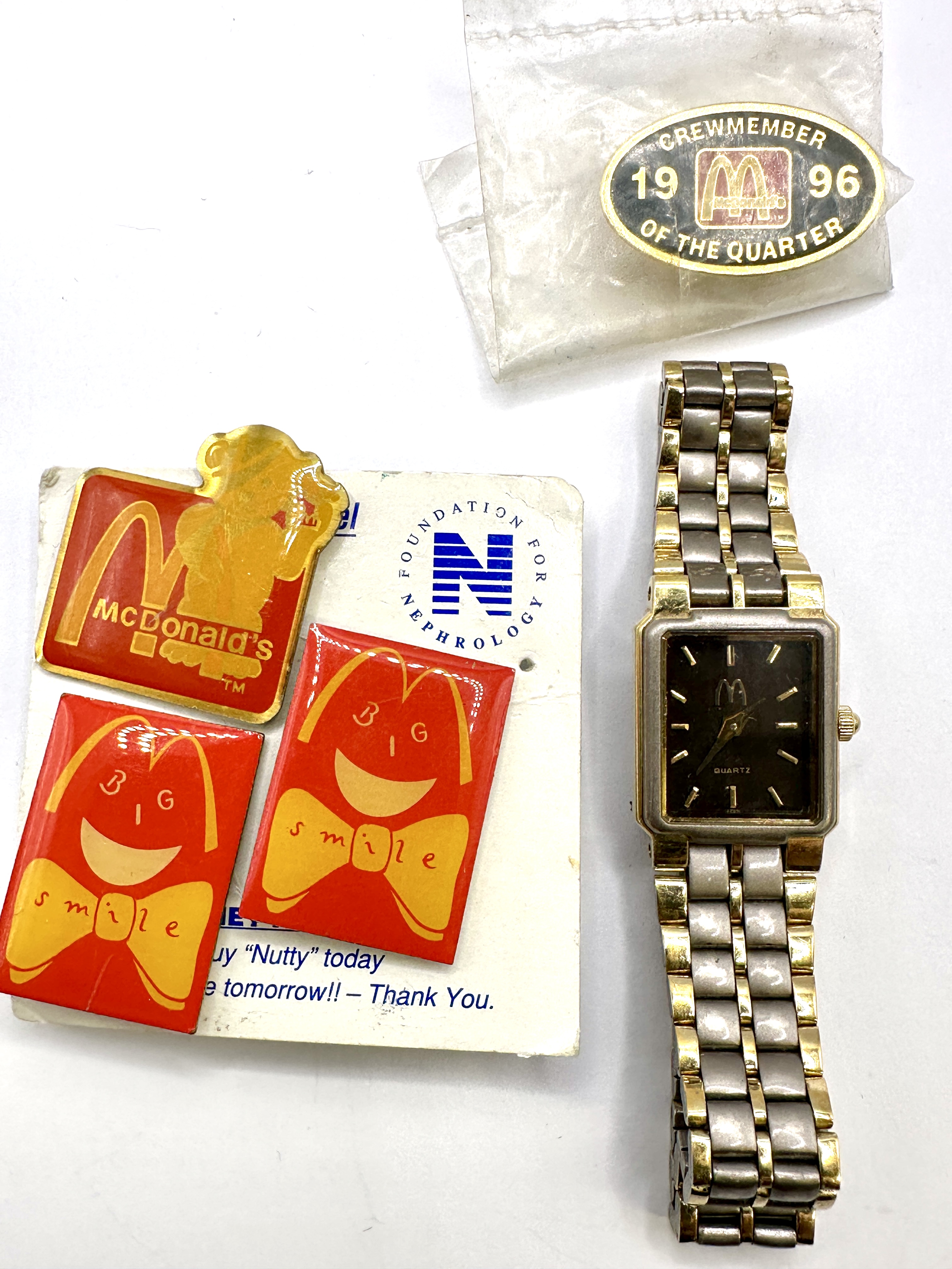 A Collection of McDonald's Corporate Memorabilia Including a Two-Tone Quartz Wristwatch and Employee Award Pins