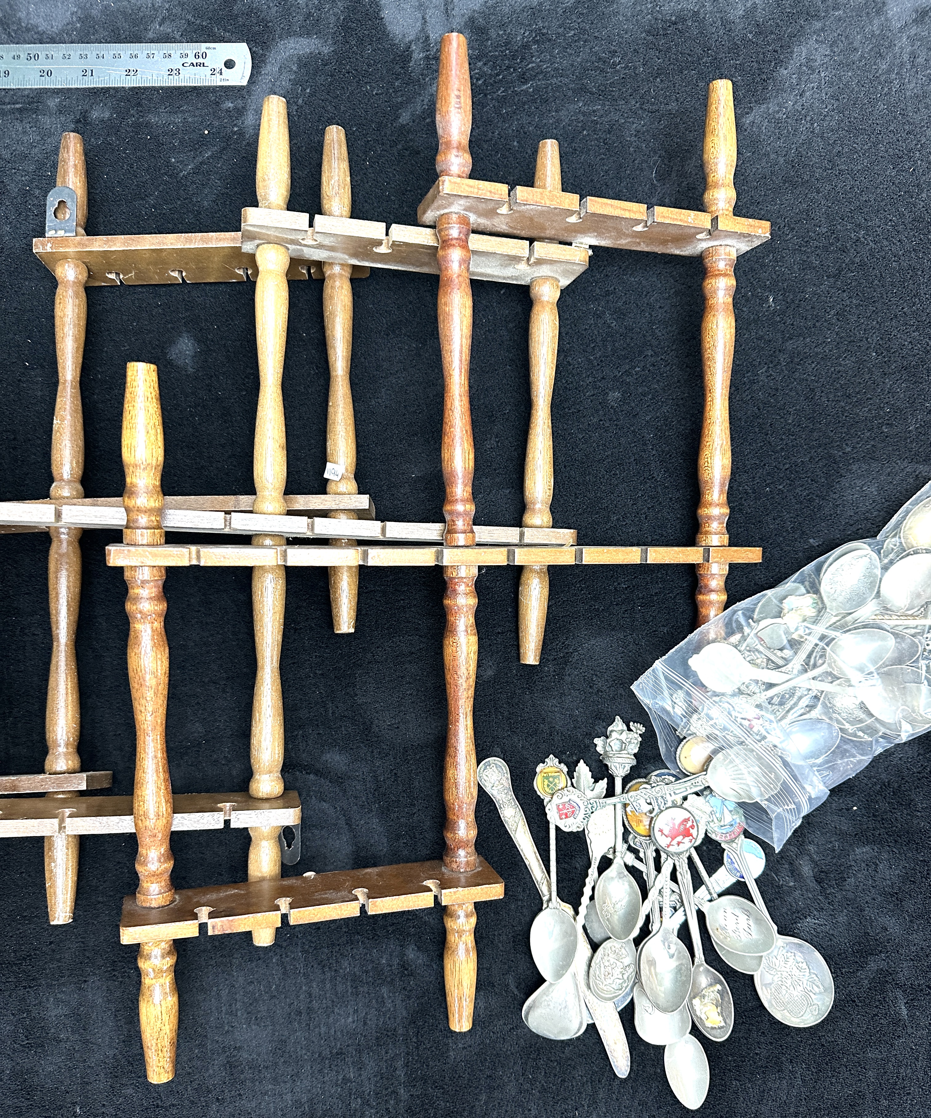 An Assortment of Souvenir Spoons and Wooden Spindle Display Racks