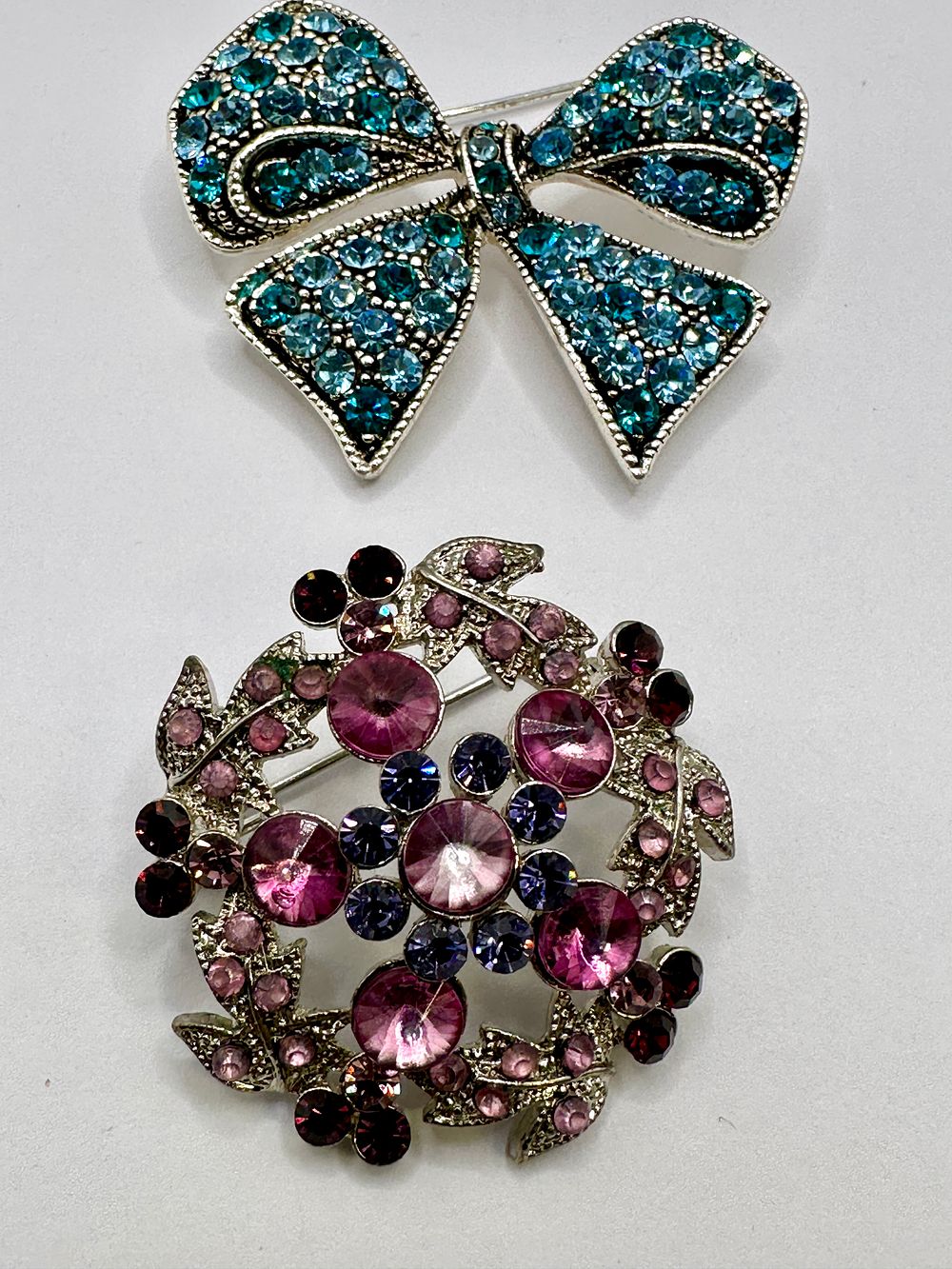 Lot 322: Two Late 20th Century Brooches, Set With Blue and Purple Stones
