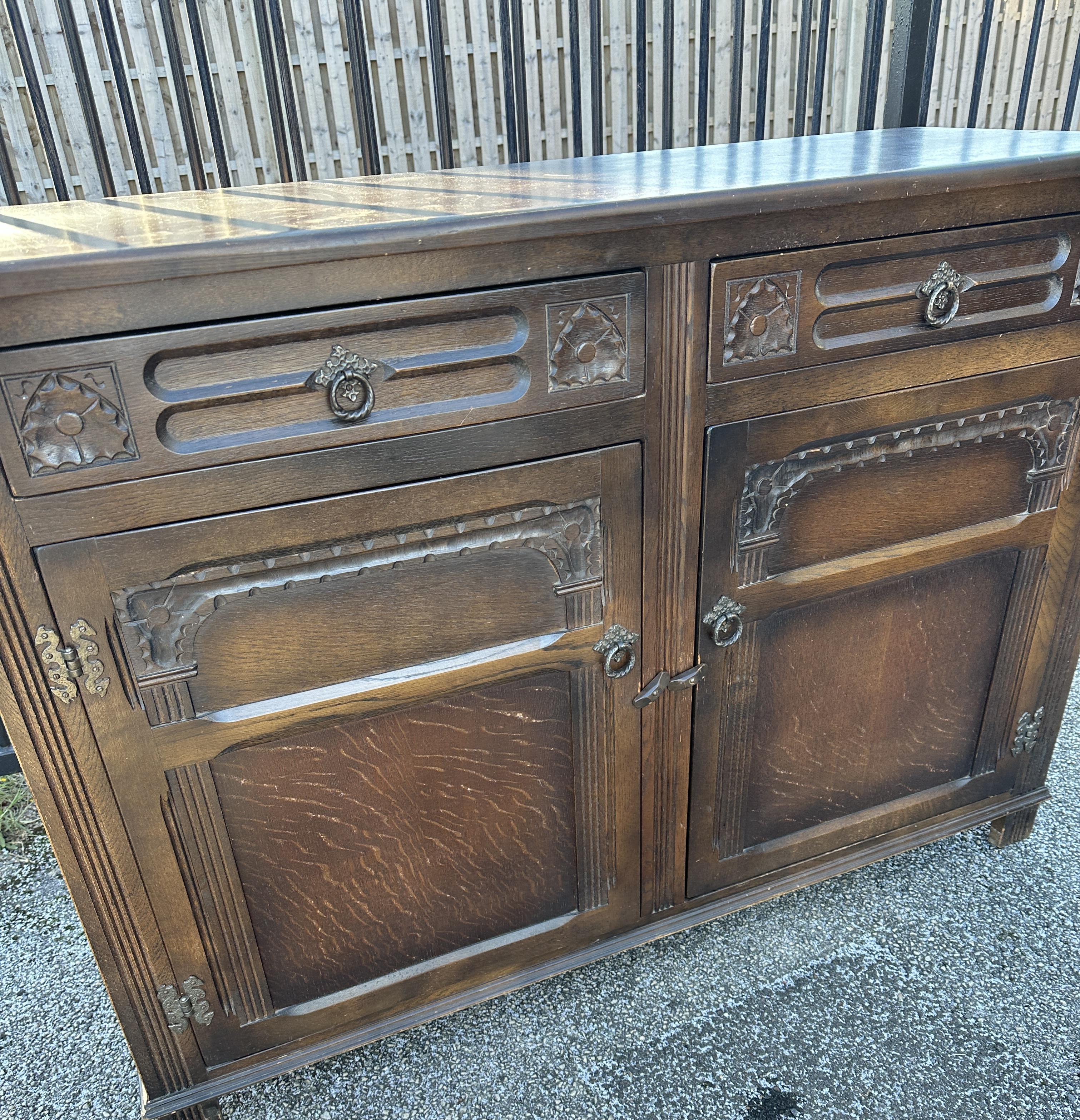 A Mid-20th Century English Carved Oak Sideboard with Butterfly Hinges