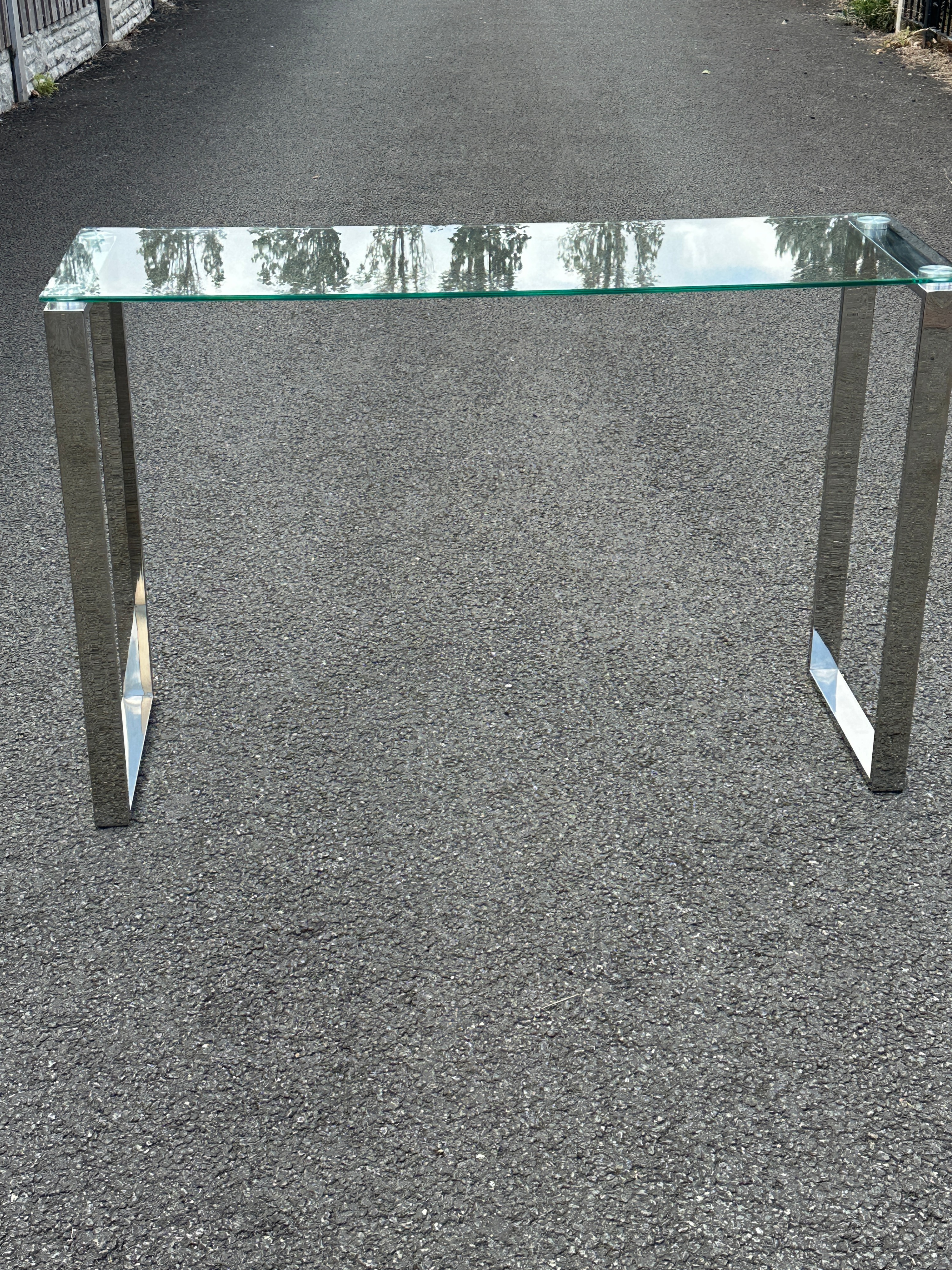 A Contemporary Glass Top Console Table with Metal U-Shaped Supports
