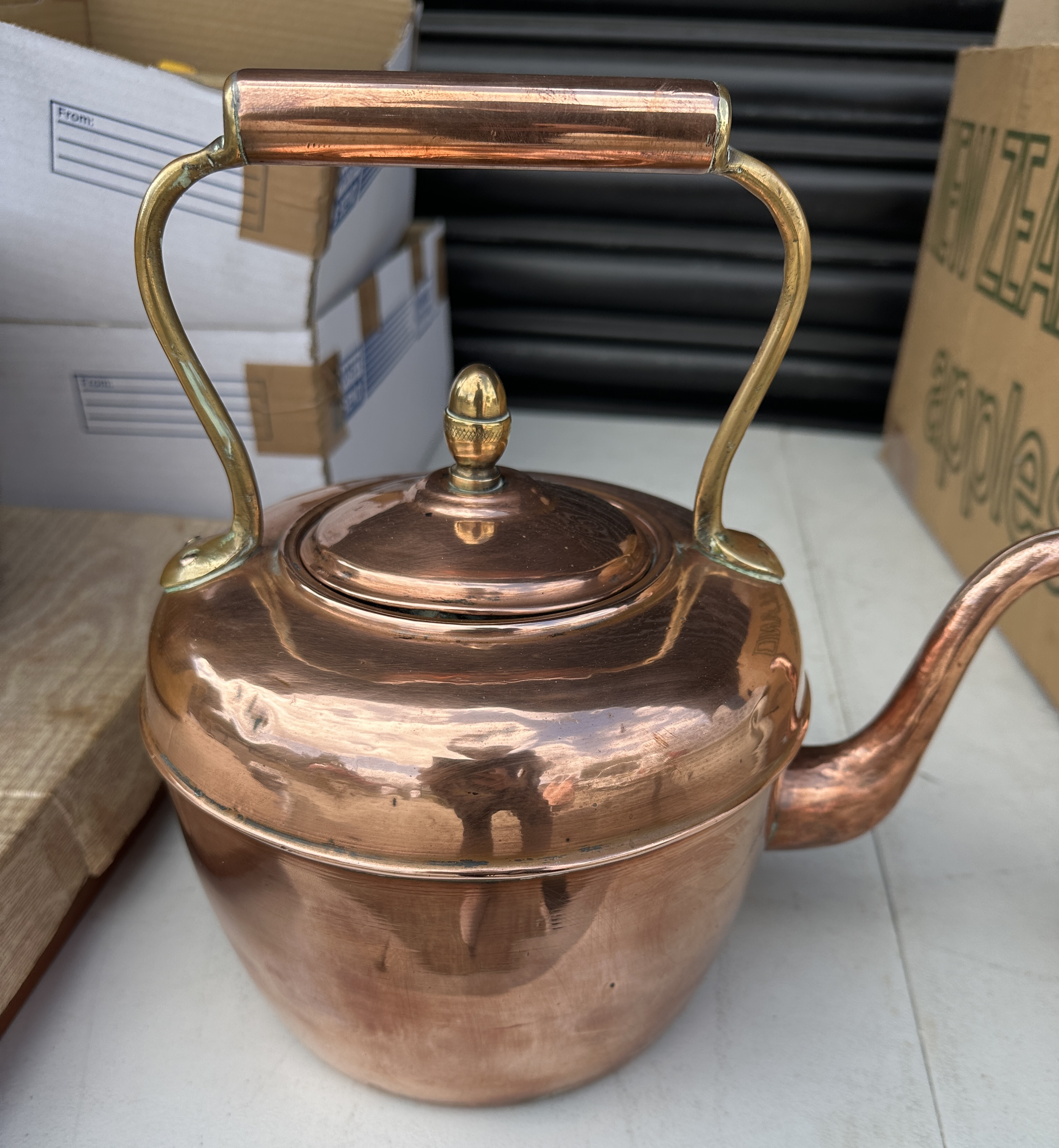 A Kettle with an Overhead Handle and a Swan-Neck Spout