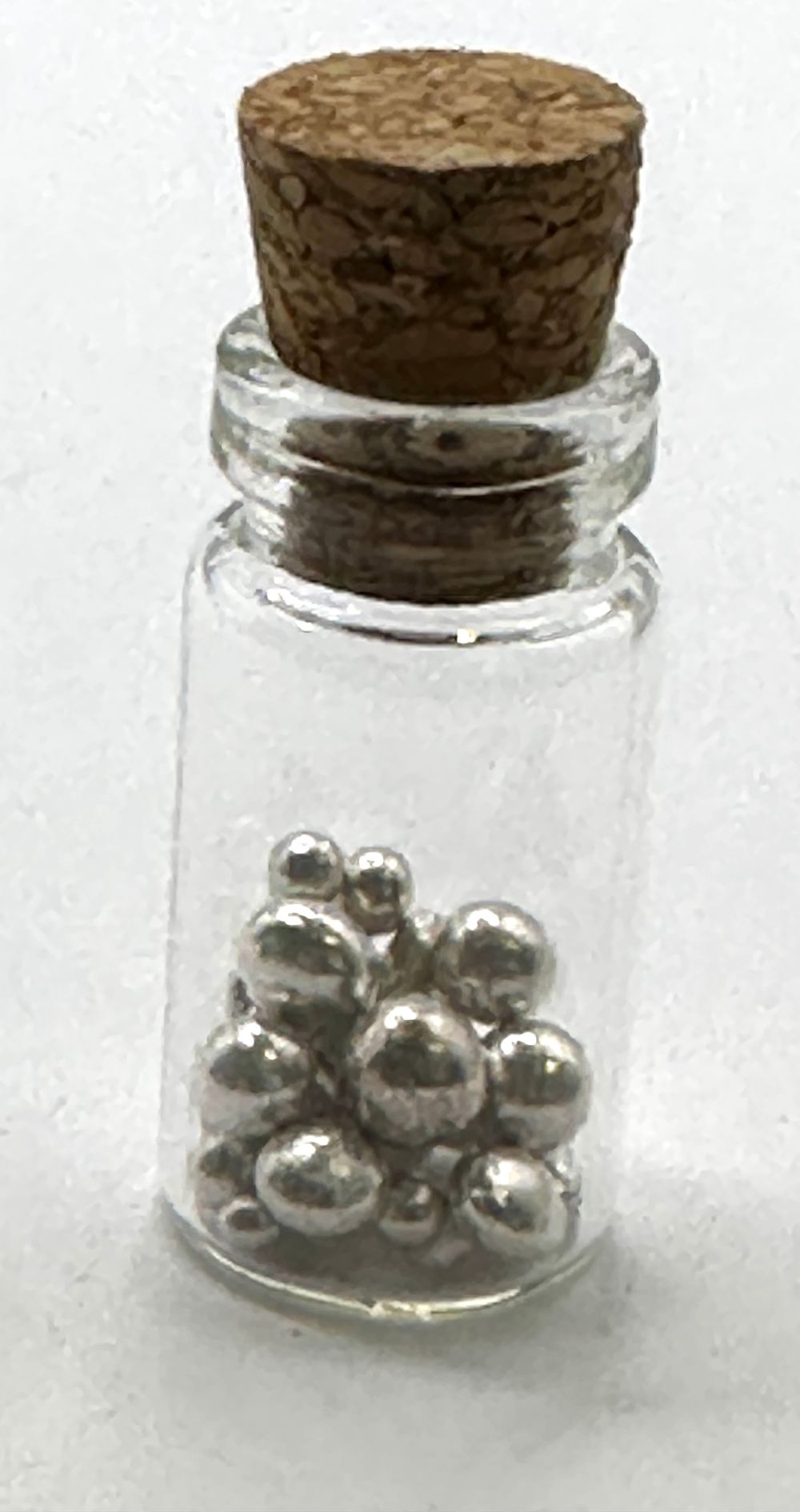 Lot 77: A Miniature Glass Vial Containing Two Grams of Fine Silver Grain