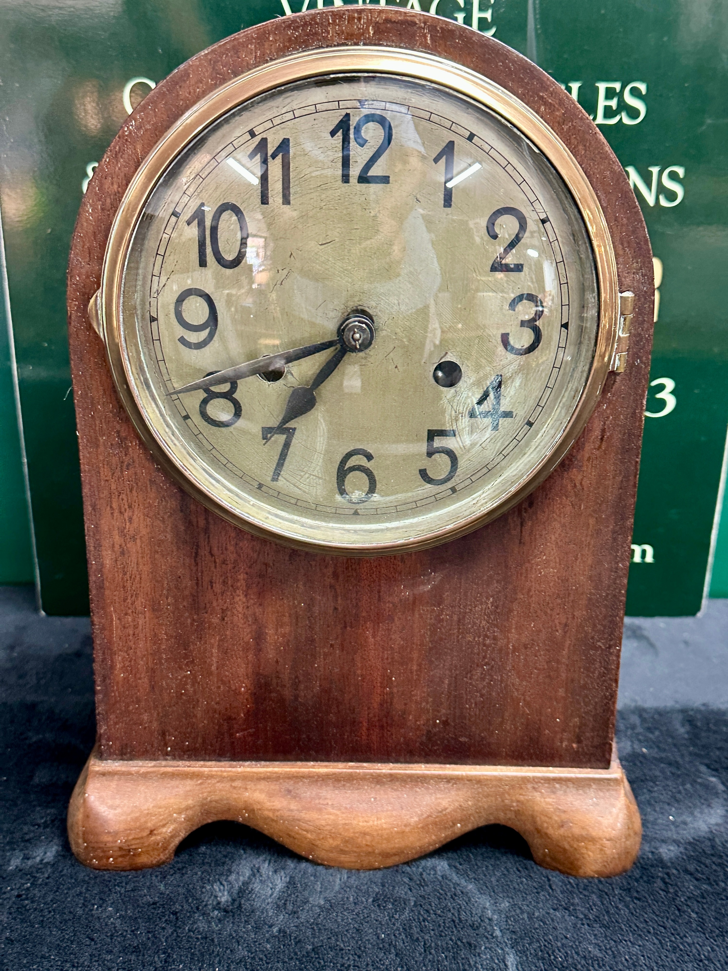 A Mid-20th Century Mahogany Mantel Clock with Serpentine Base and Winding Key
