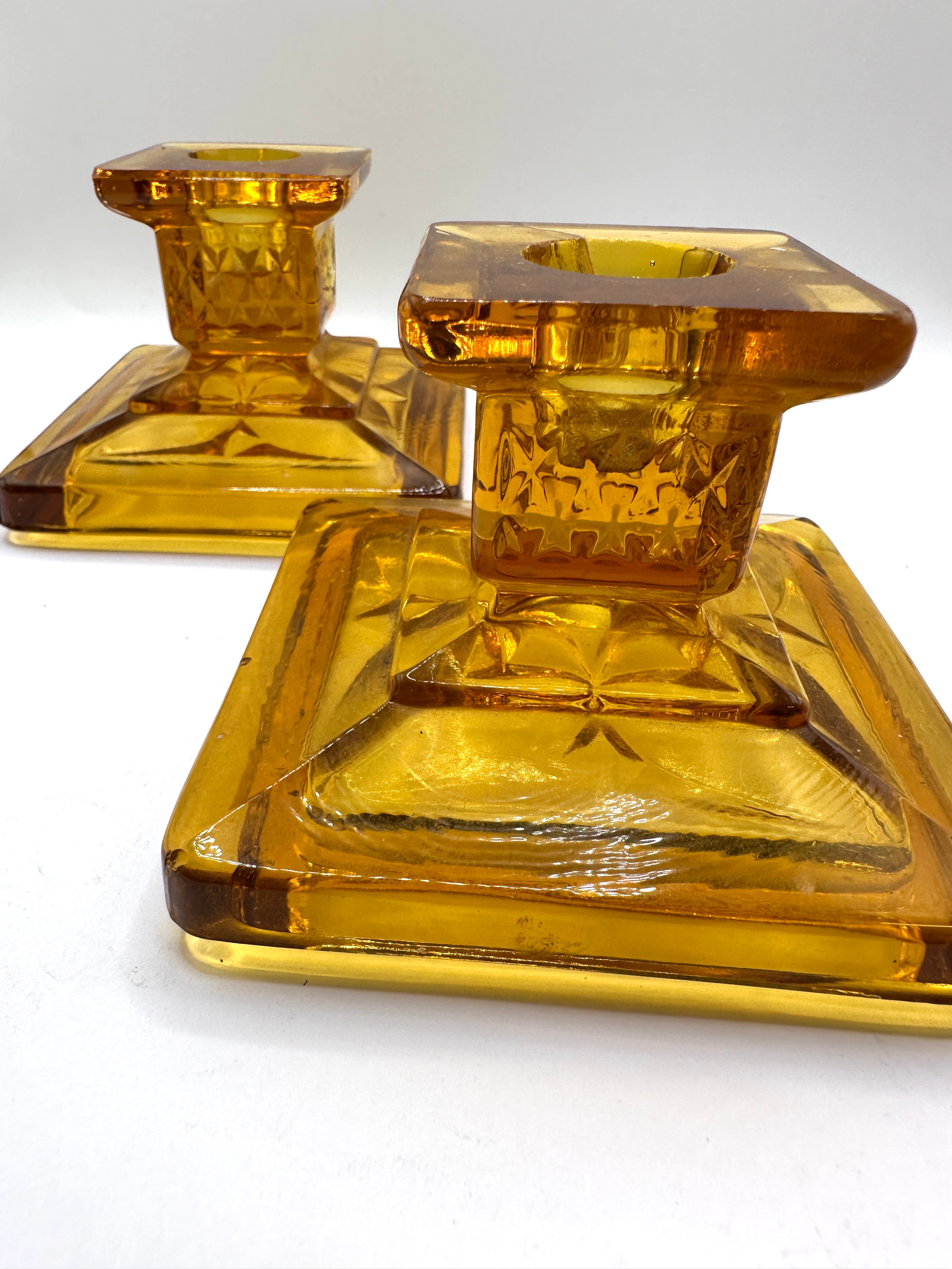 A Pair of Candlesticks with Tiered Bases and Starburst Motifs