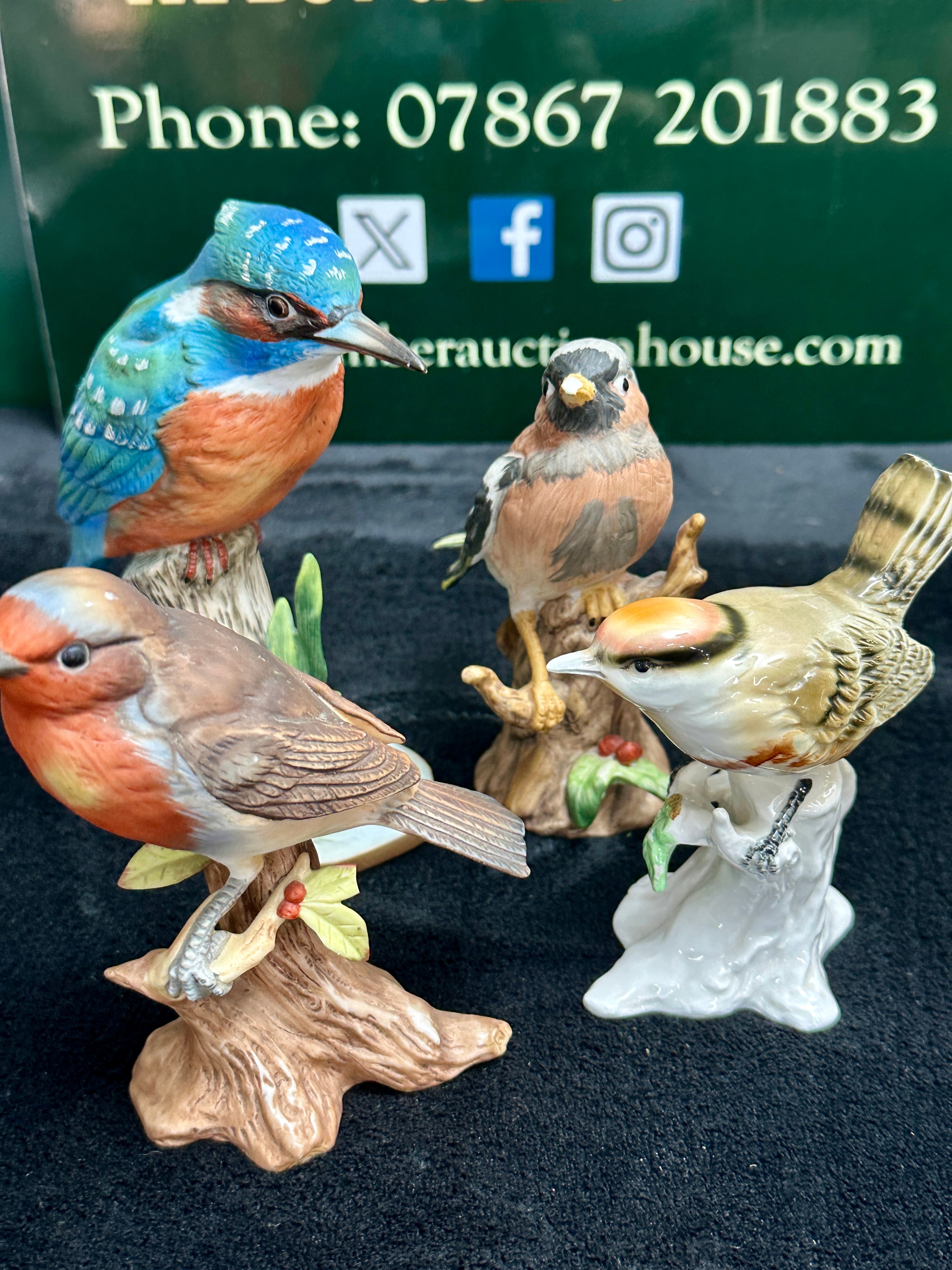 An Assortment of Four Hand-Painted Bird Figurines with Matte and Gloss Finishes