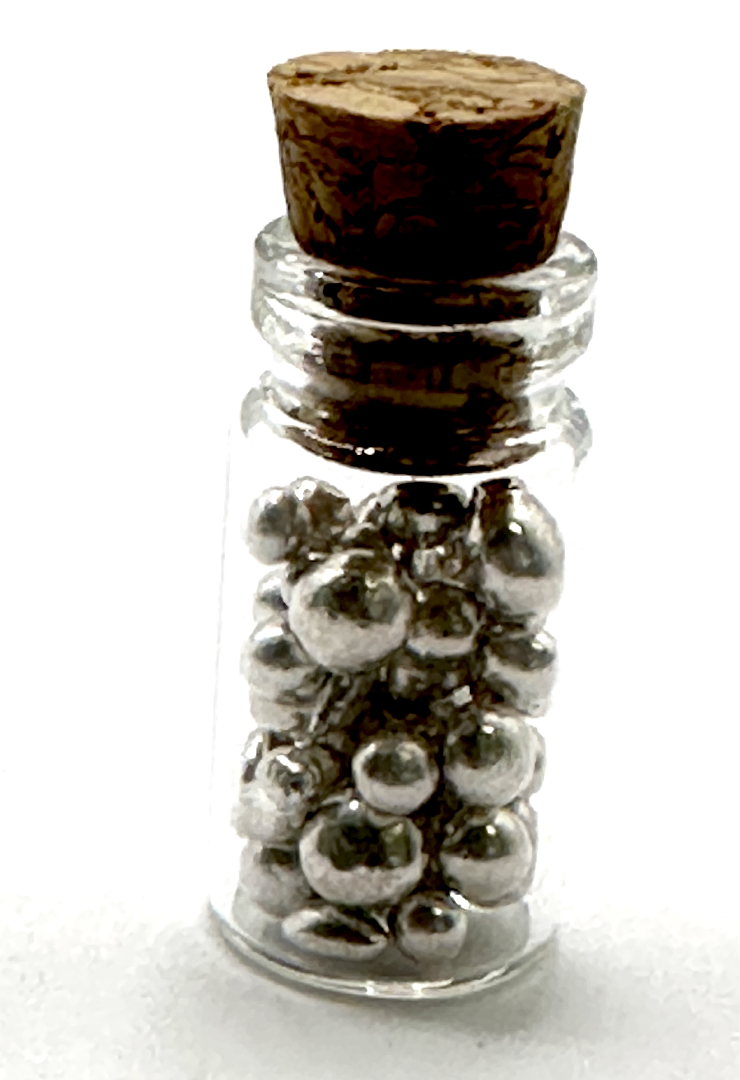 An Assortment of Silver Bullion Shot in a Glass Vial