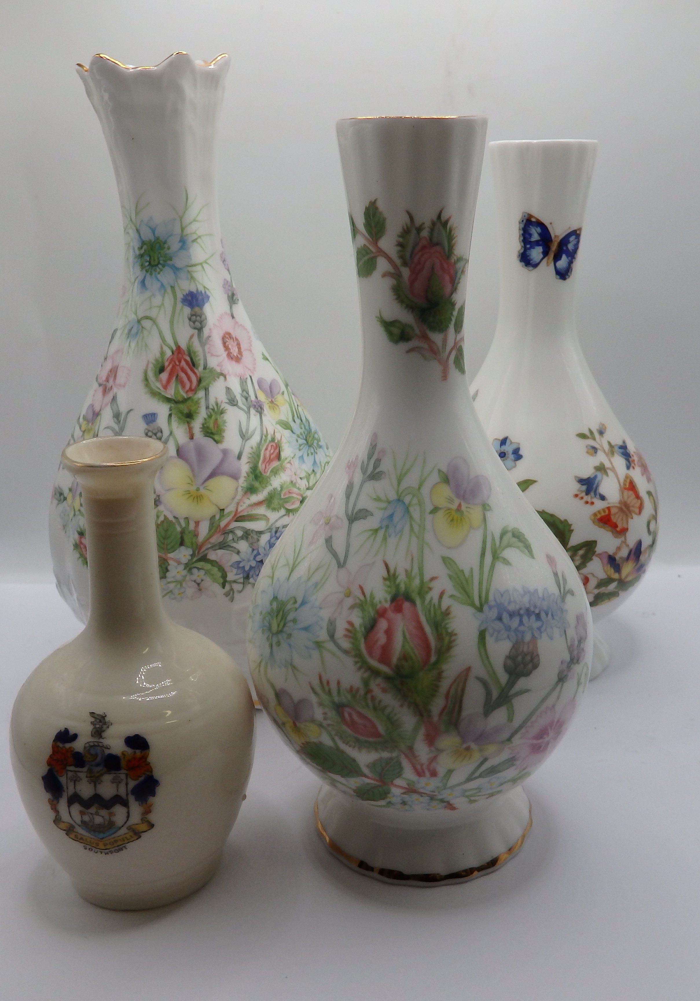 A Collection of Four Botanical and Heraldic Ceramic Vases
