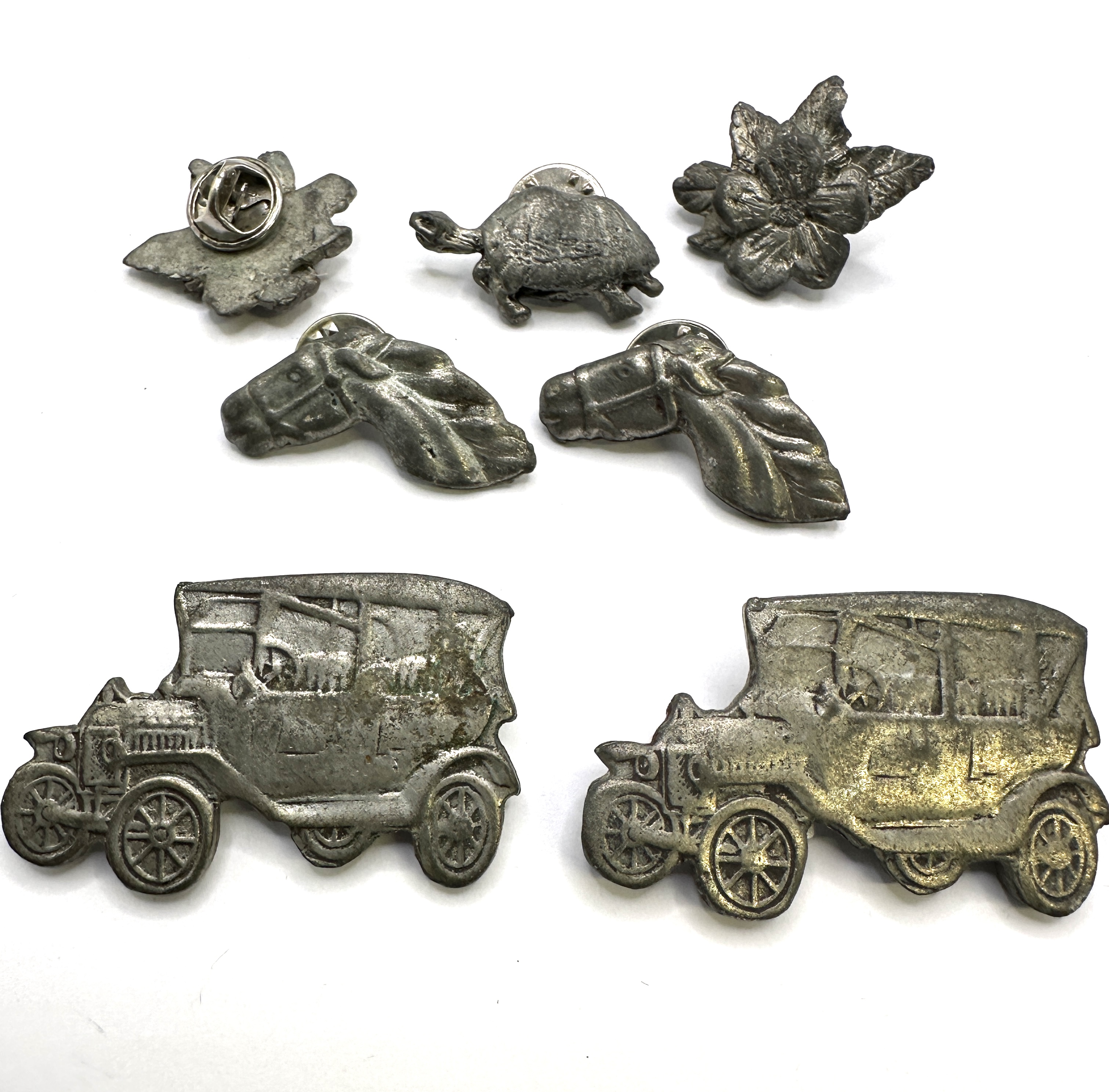 A Collection of Seven Figural Novelty Lapel Pins