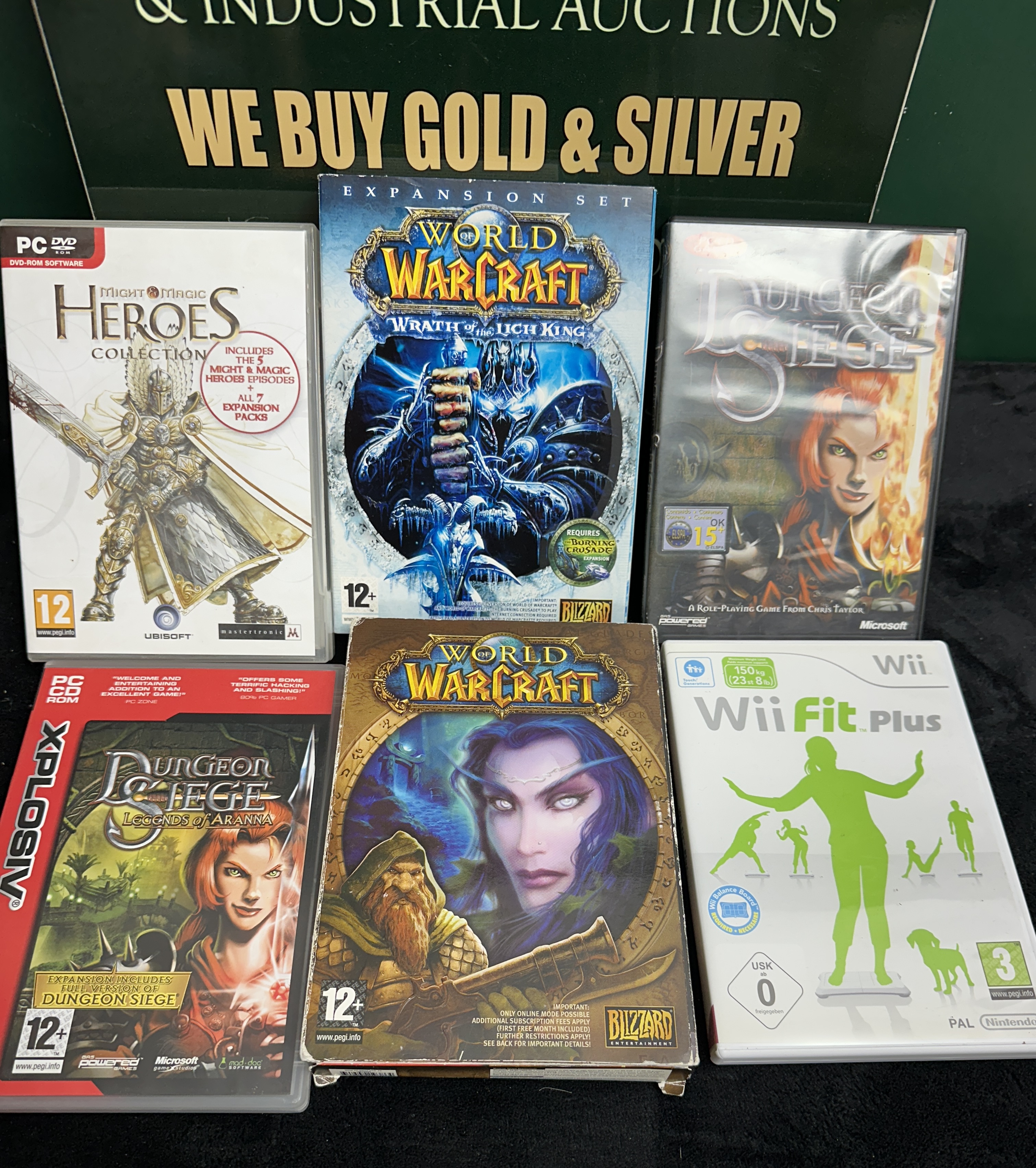 An Assortment of Blizzard World of Warcraft and Microsoft Dungeon Siege Video Games