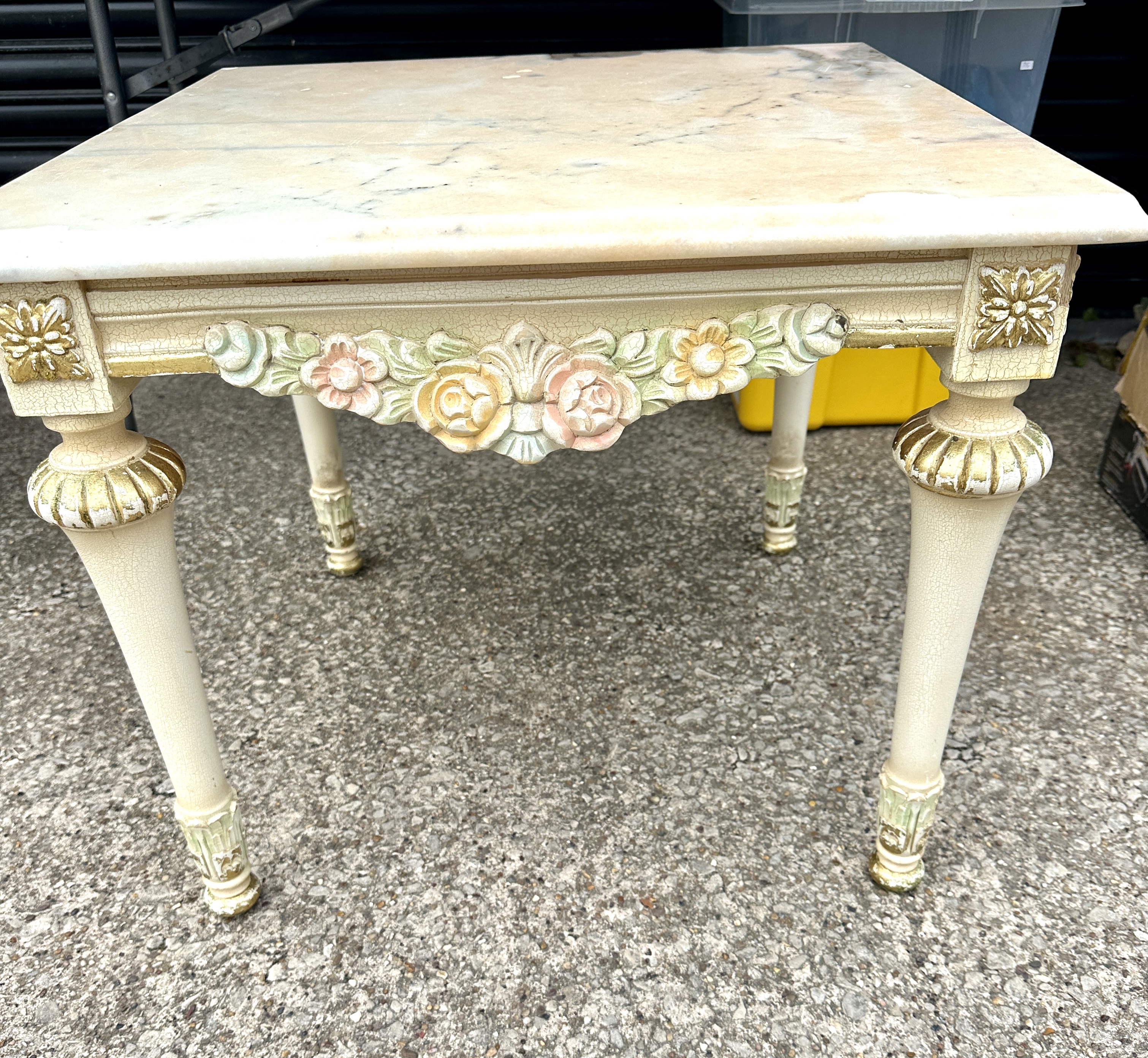 A Marble Side Table, featuring a square bevelled top and floral swags