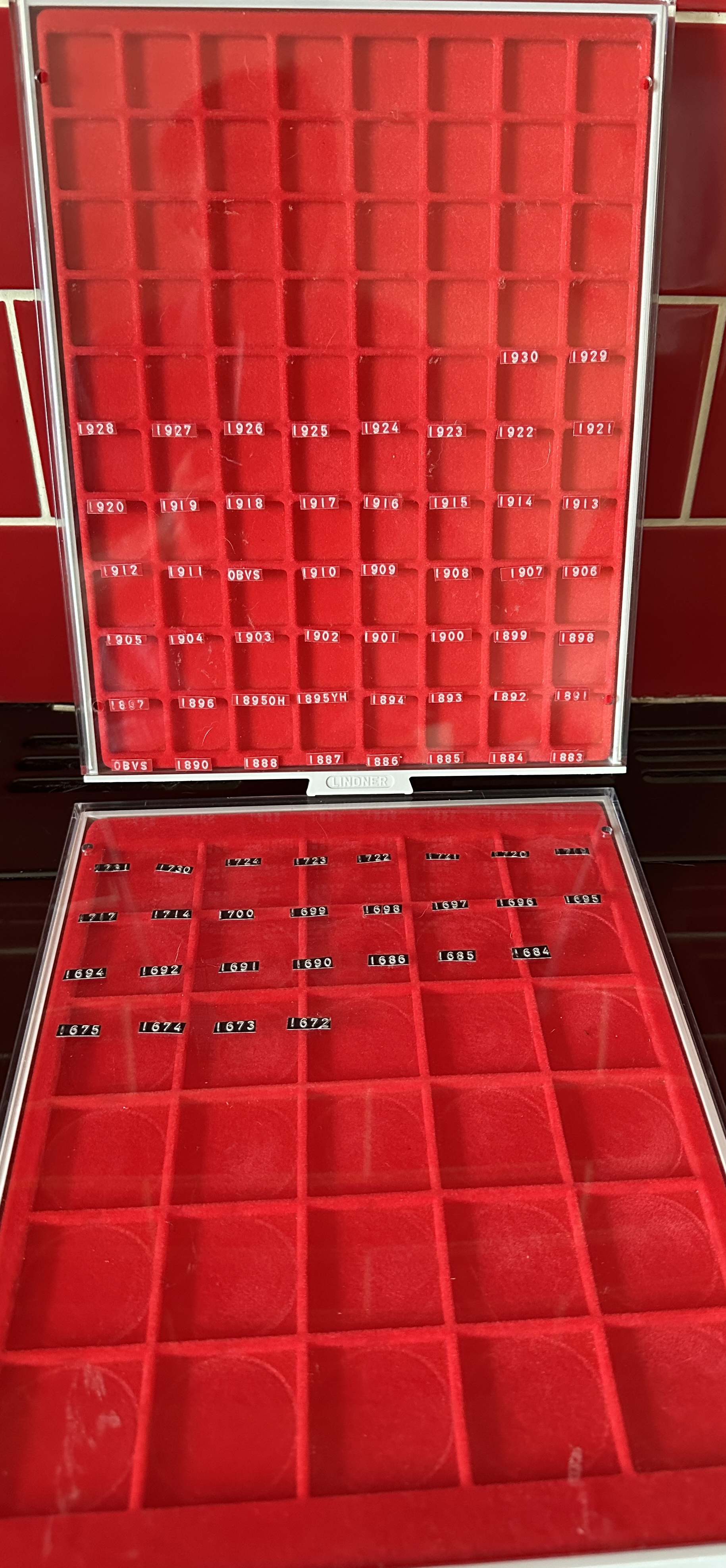 A pair of Lindner Stackable Coin Storage and Display Trays