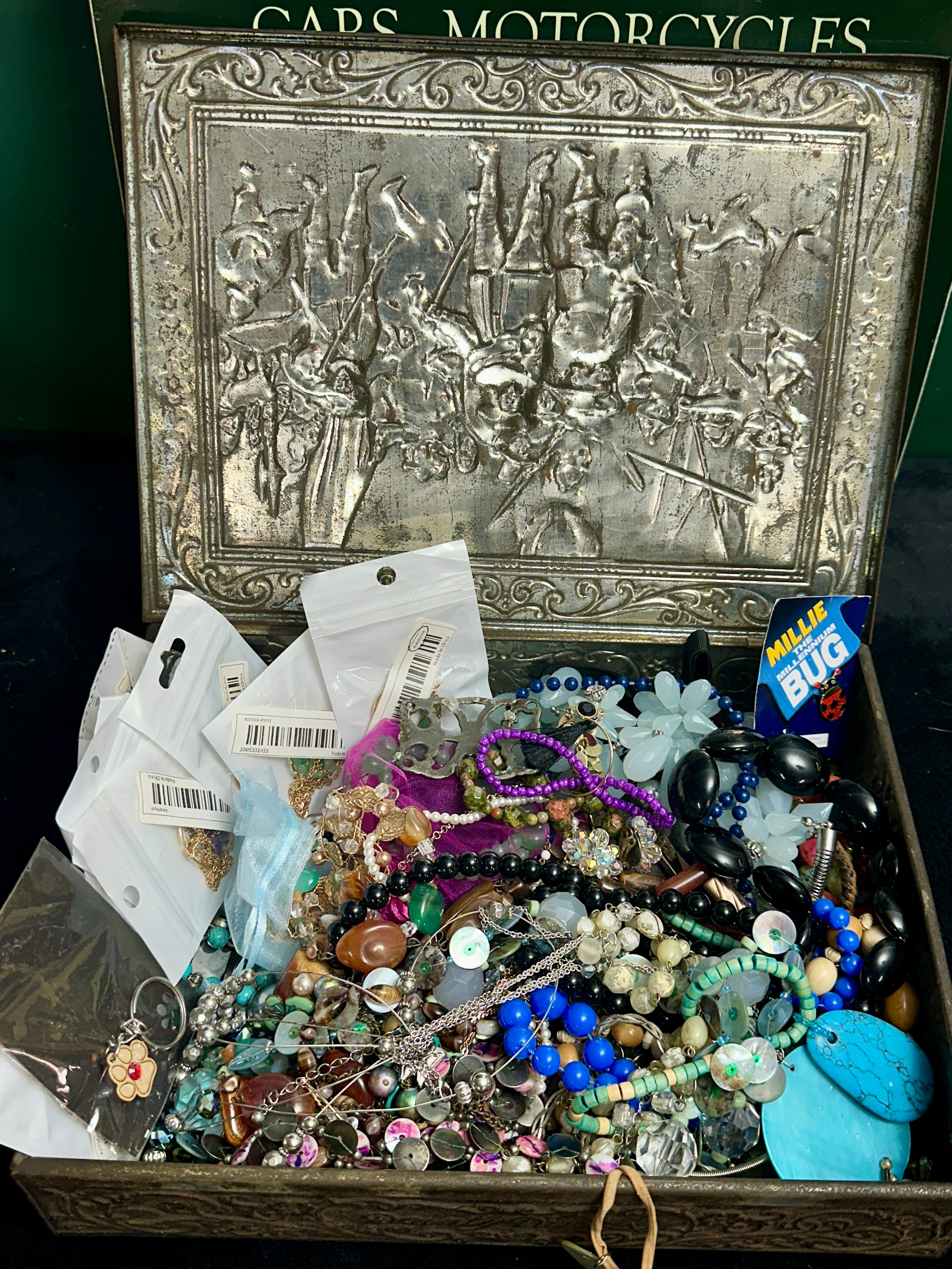 A Relief-Decorated Metal Box Containing a Collection of Costume Jewellery