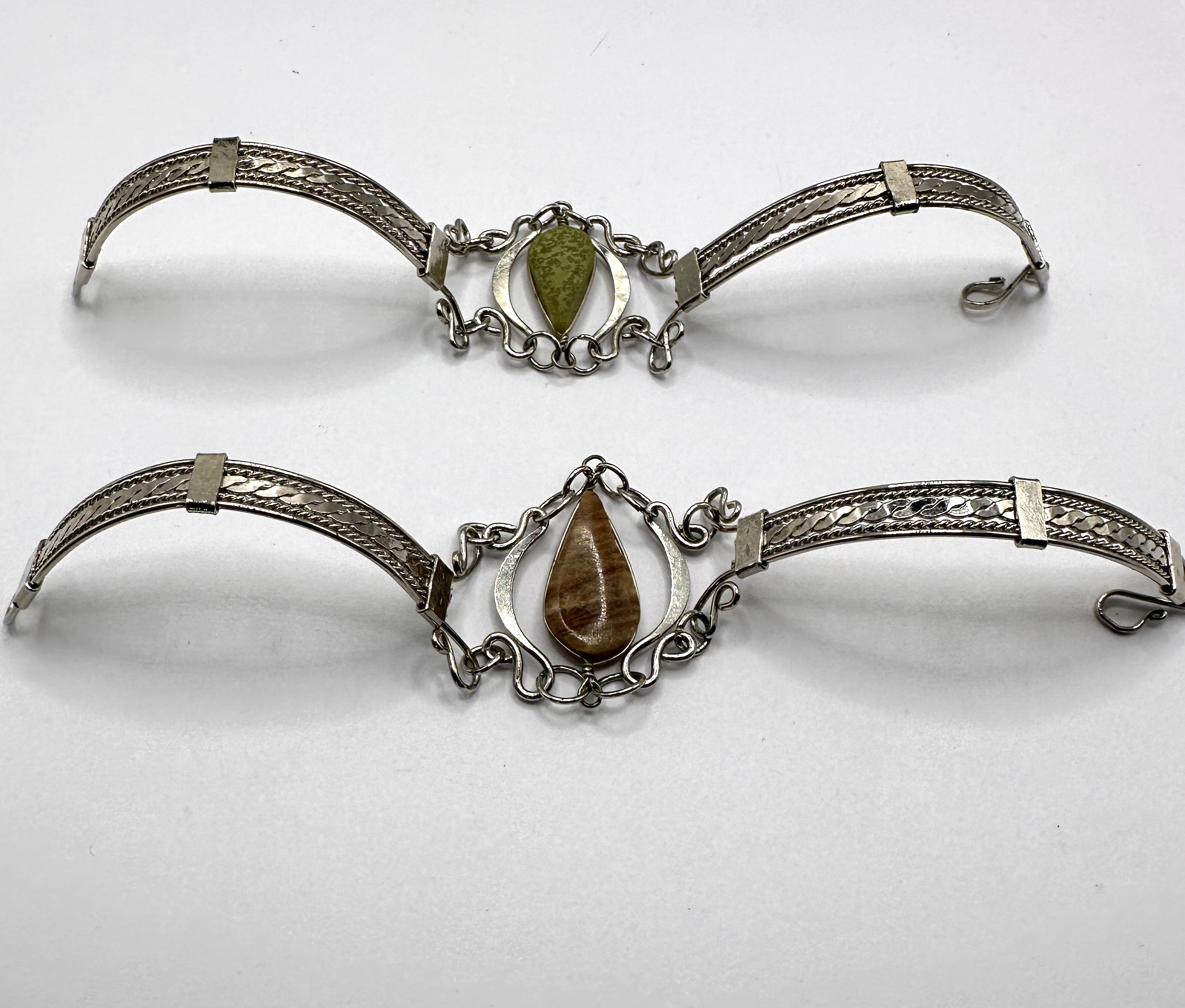 A Pair of White Metal Link Bracelets with Cabochon Stone Insets