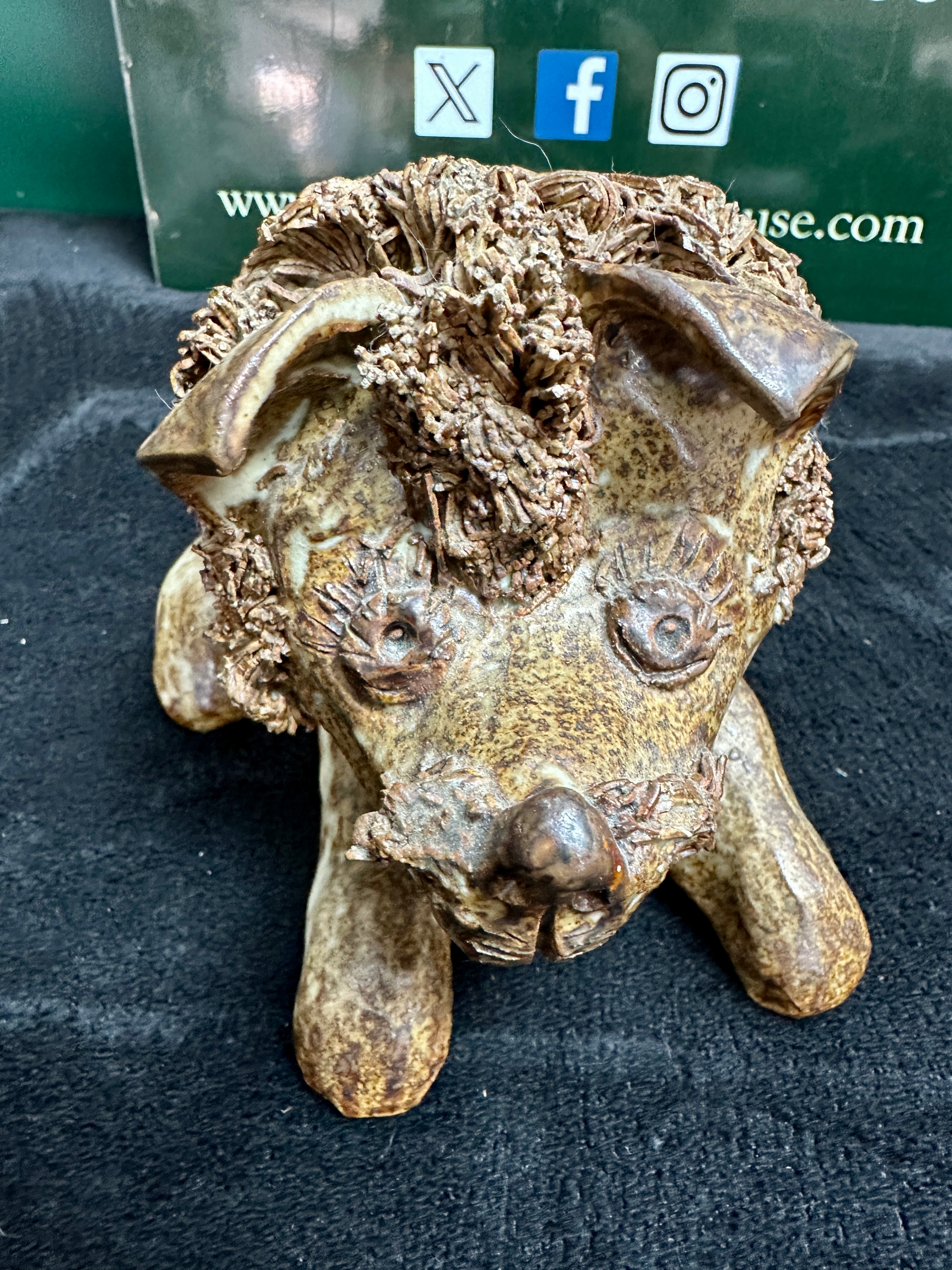 A Reclining Lion Figurine with Textured Mane