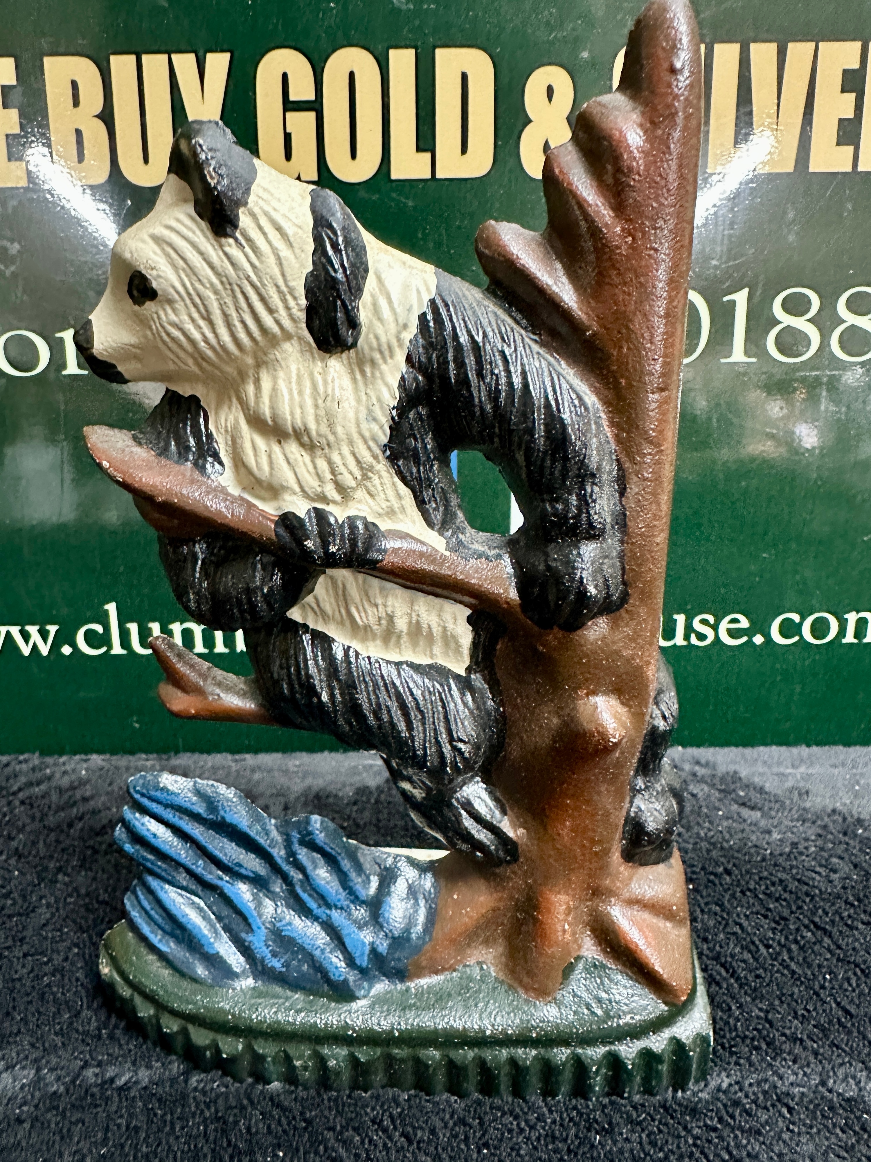 A Doorstop Depicting a Giant Panda Climbing a Tree