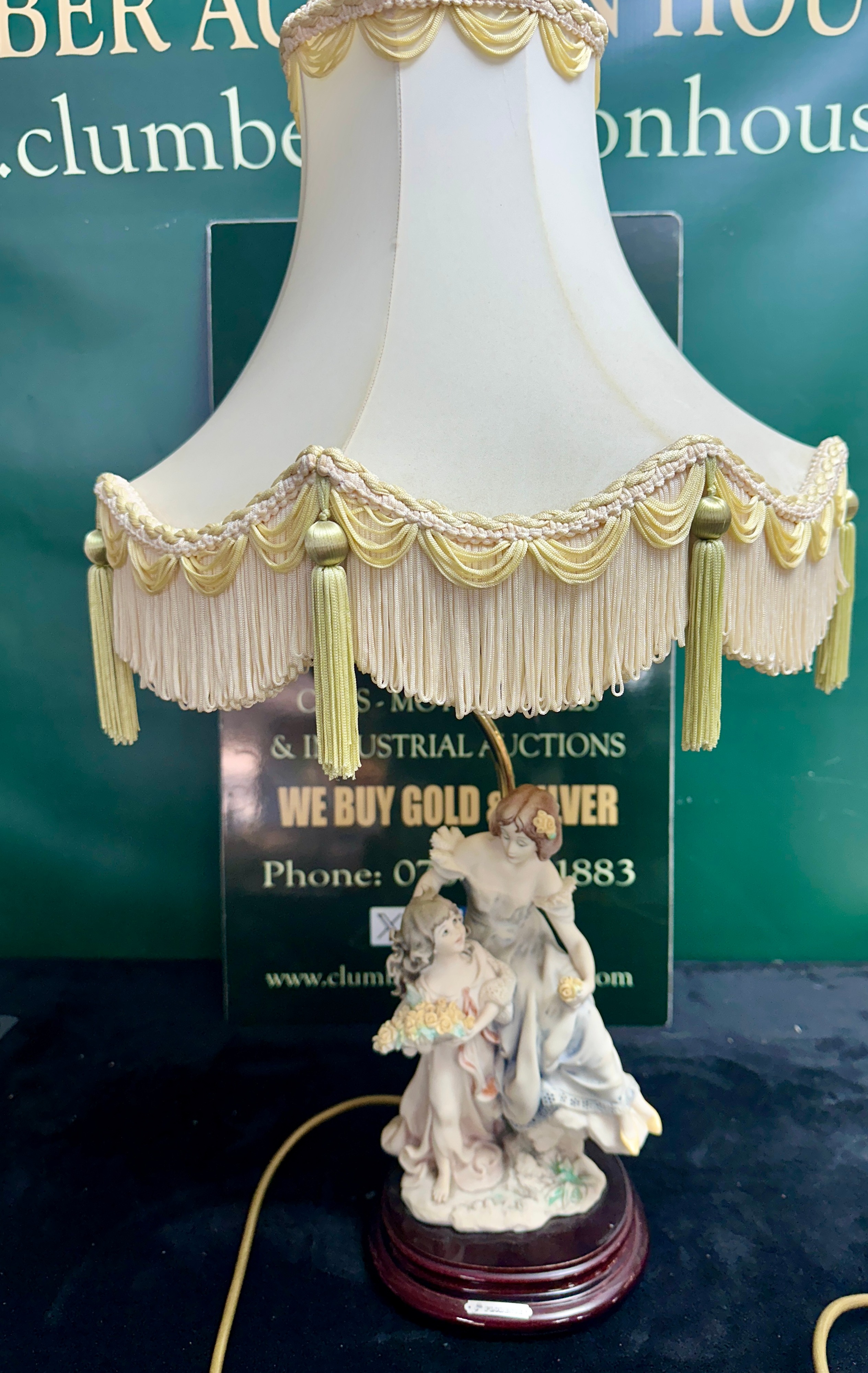 A Figural Table Lamp Featuring Two Female Figures With A Tasseled Shade