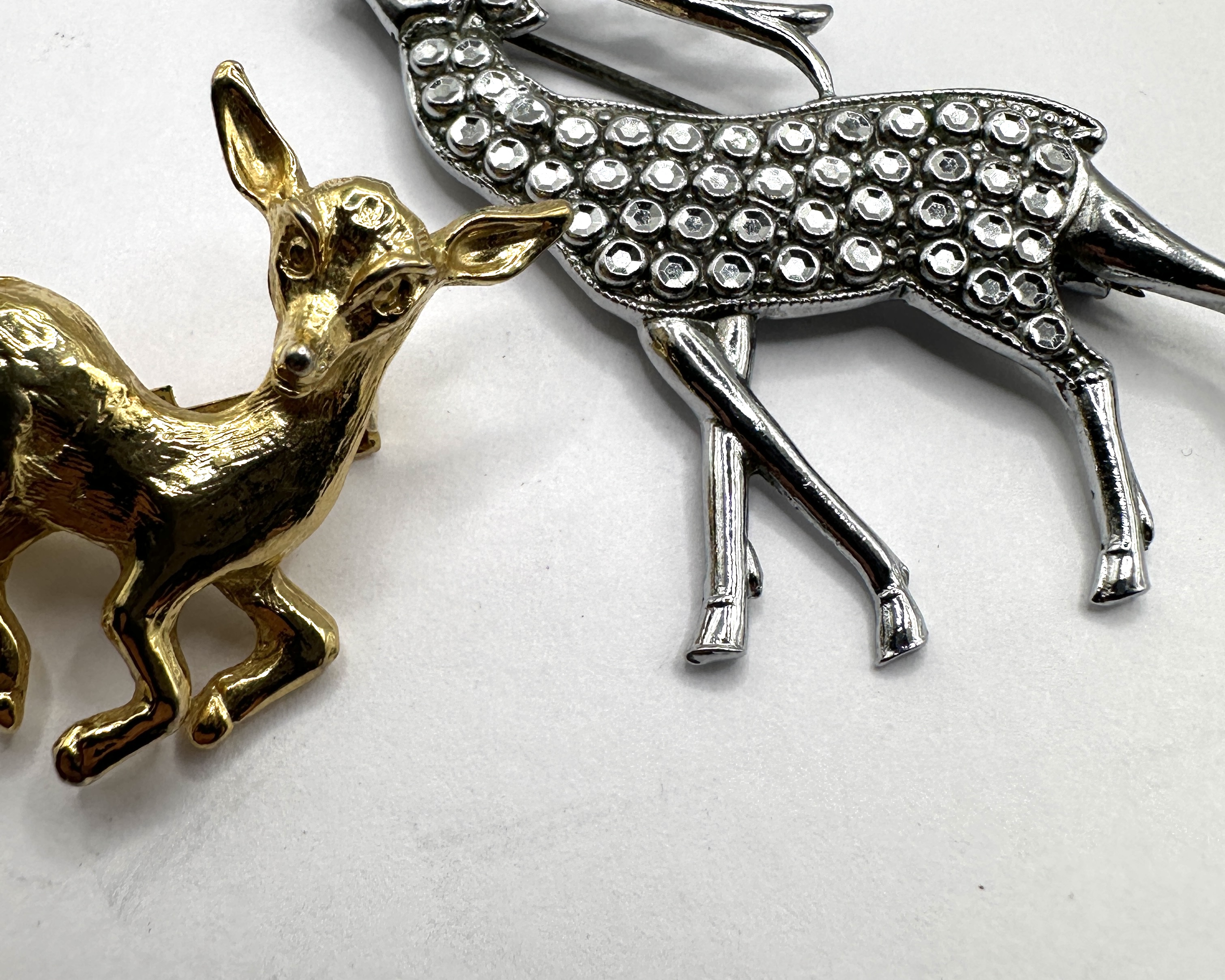 Two Metal Deer Brooches, one set with rhinestones