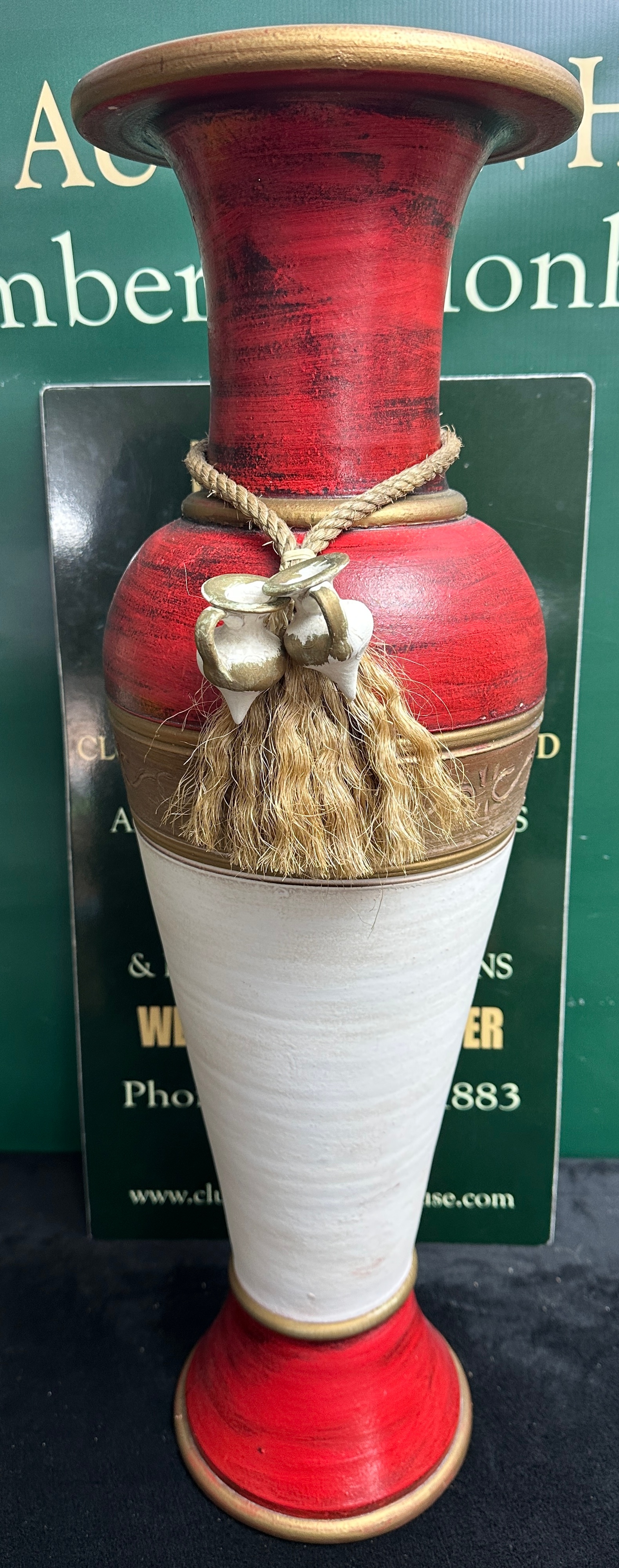 A Tall Vase with Rope and Tassel Decoration