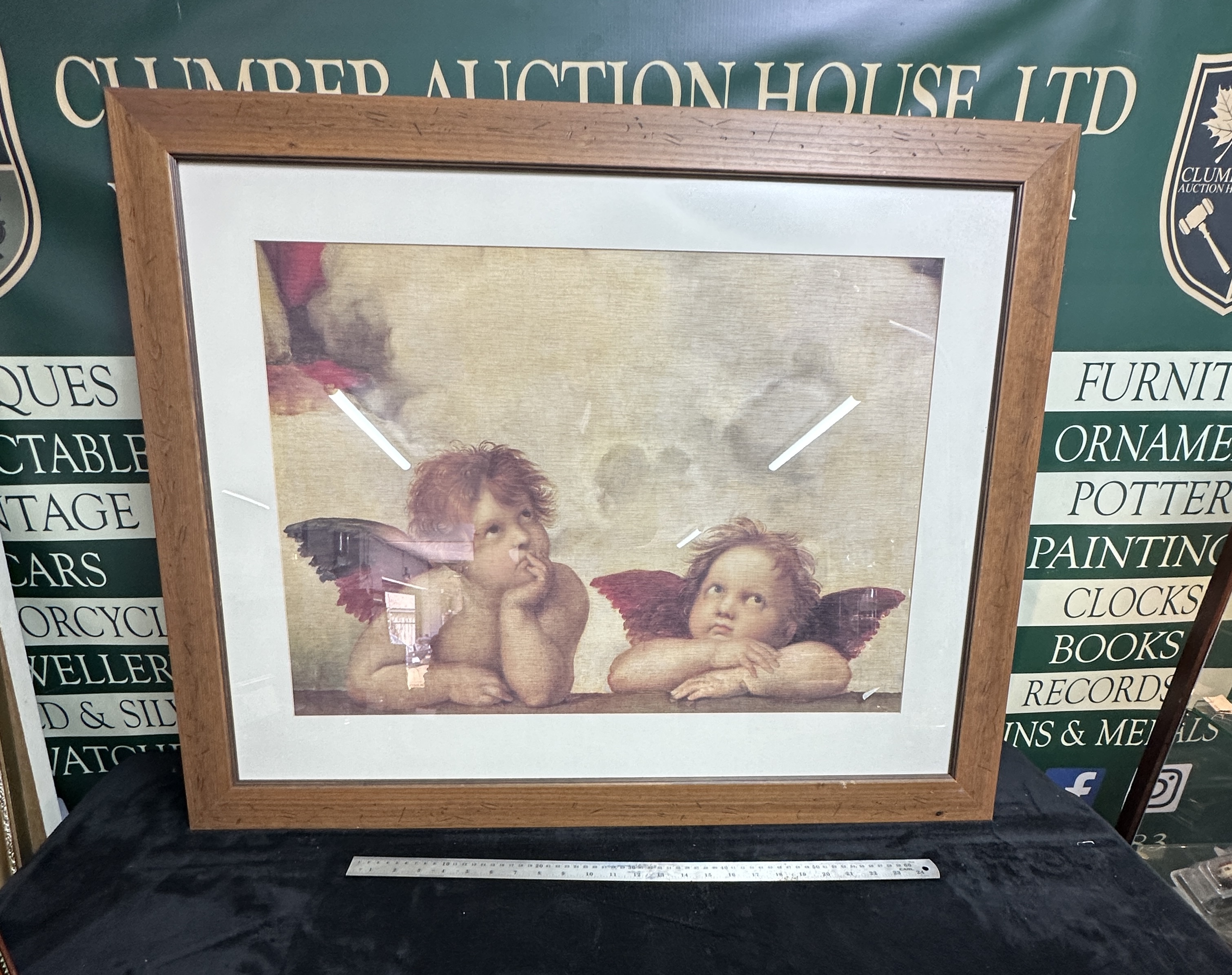 A Framed Print Depicting Cherubs From The Sistine Madonna