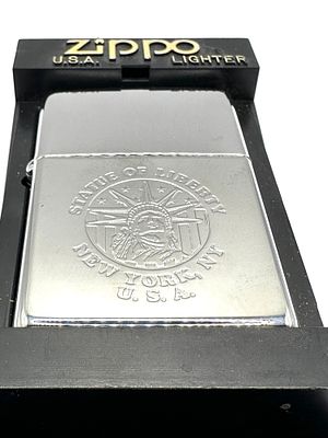 A USA Zippo Statue of Liberty Lighter with Plastic Display Stand