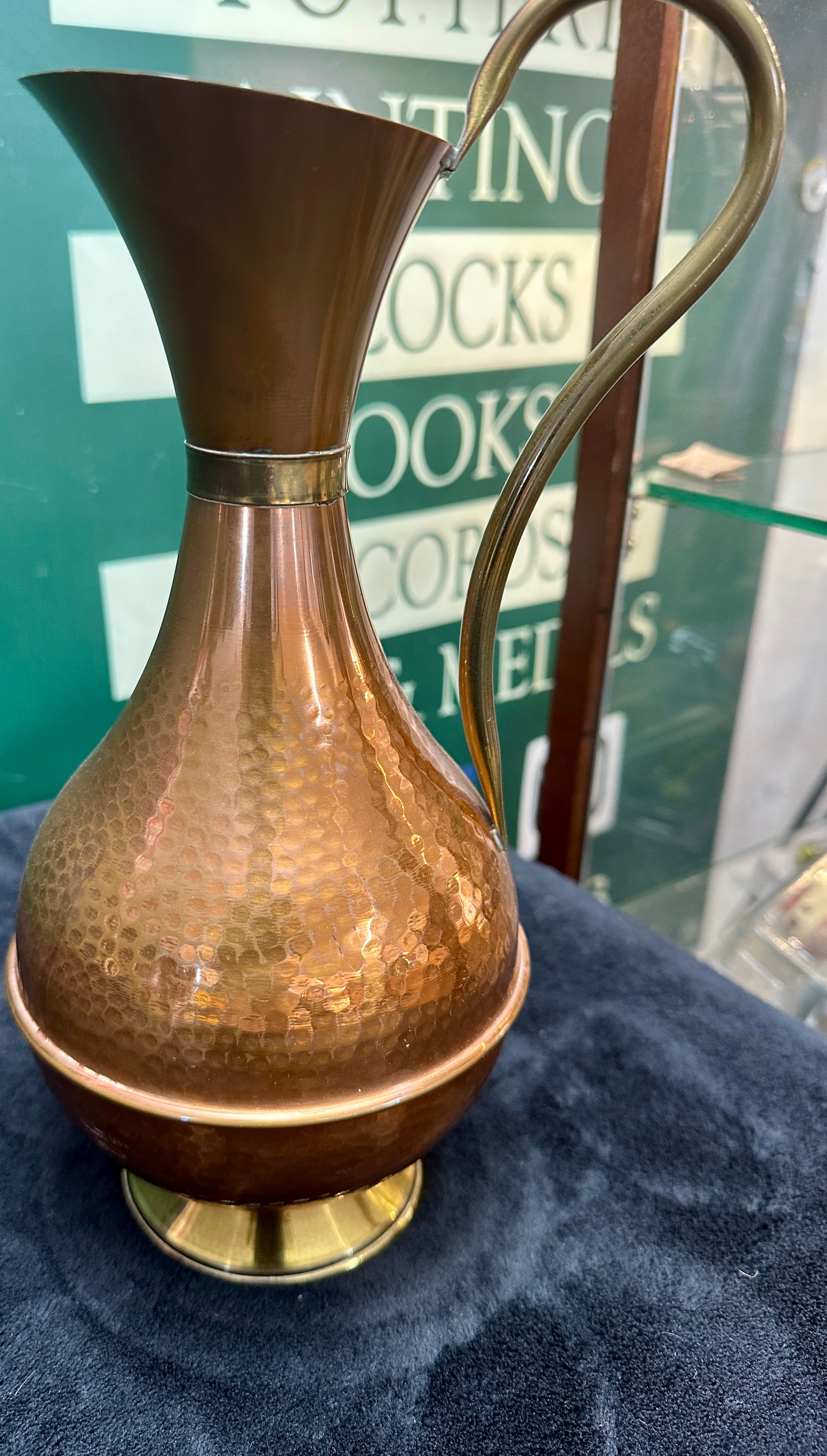 A Metal Ewer with Hand-Hammered Finish and Pedestal Foot