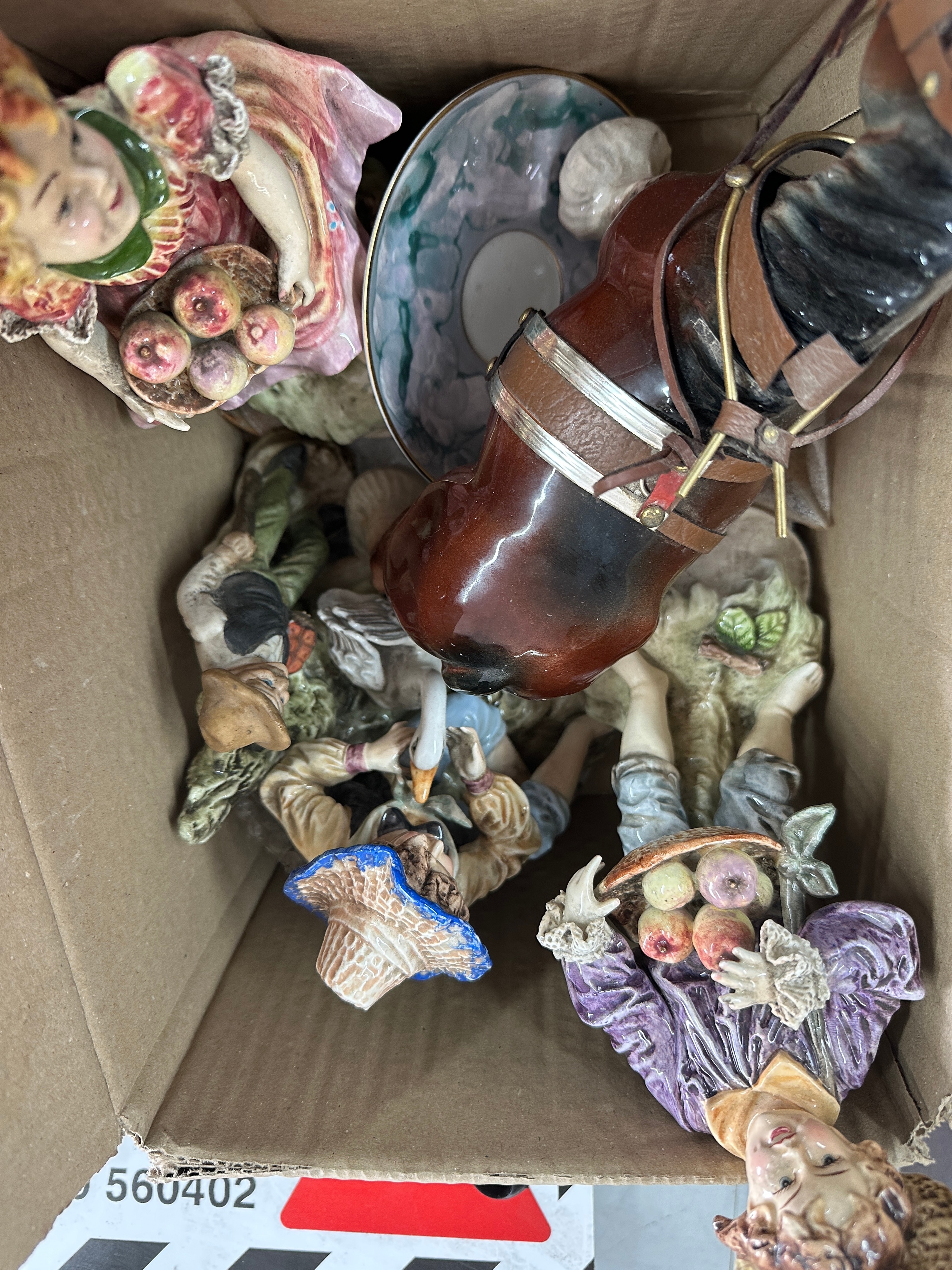 An Assortment of Glazed Ceramic Pastoral Figural Ornaments and Saucer