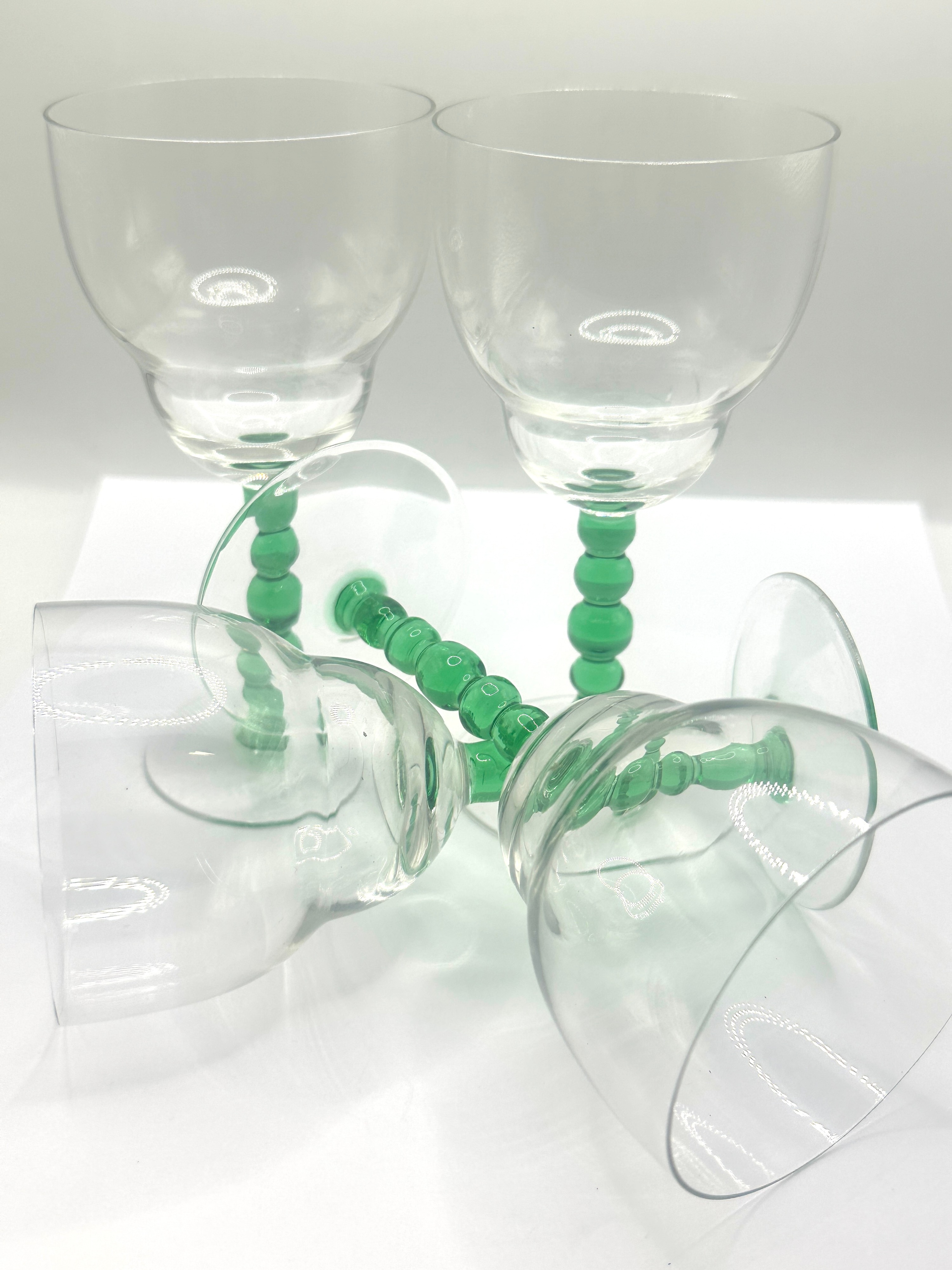A Set of Four Stemware Glasses with Beaded Green Stems