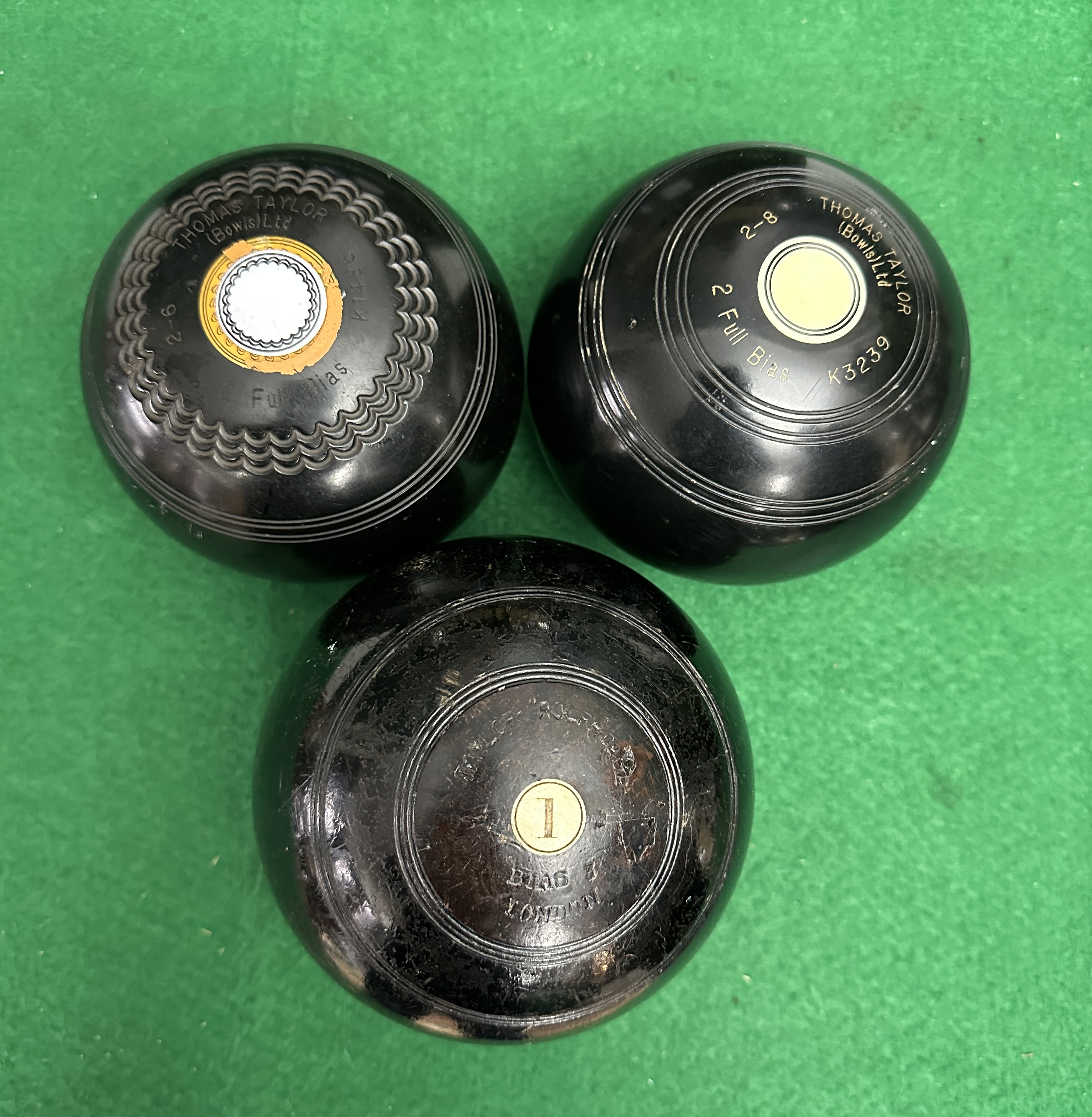 Three Black Composition Lawn Bowls, Thomas Taylor and Taylor-Rolph Co