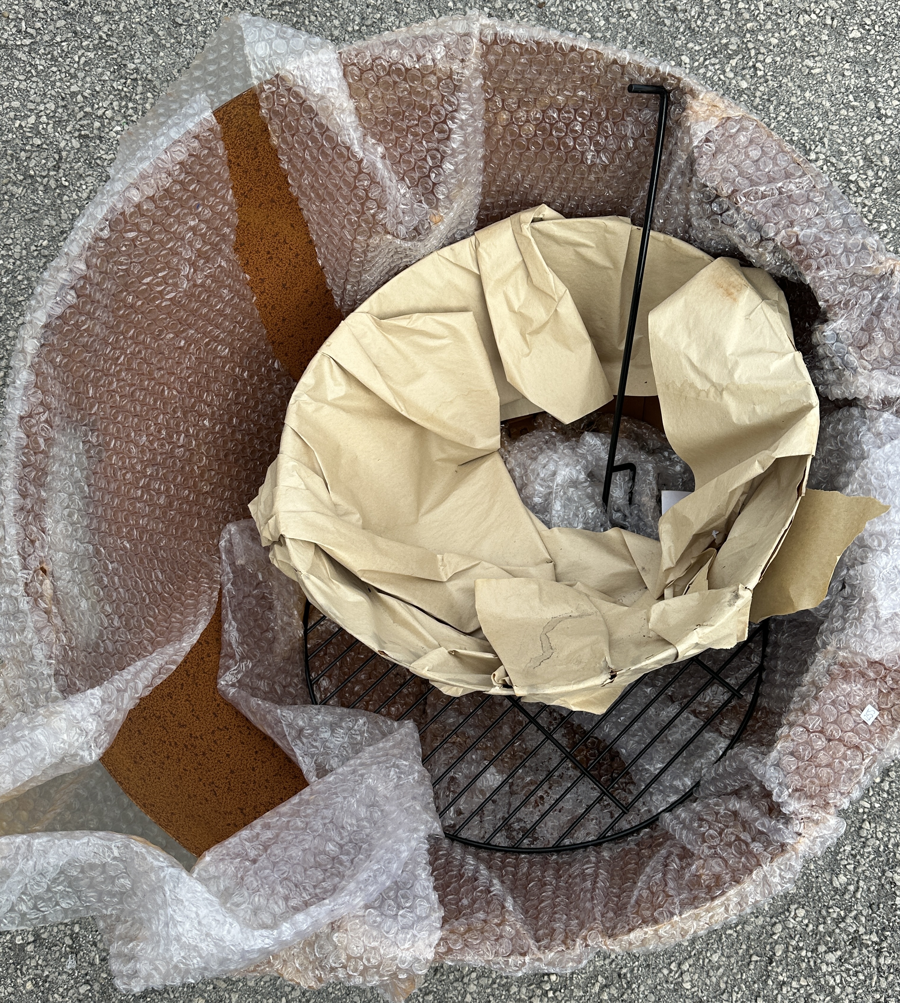 A Large Metal Garden Fire Pit Bowl with Grate and Poker