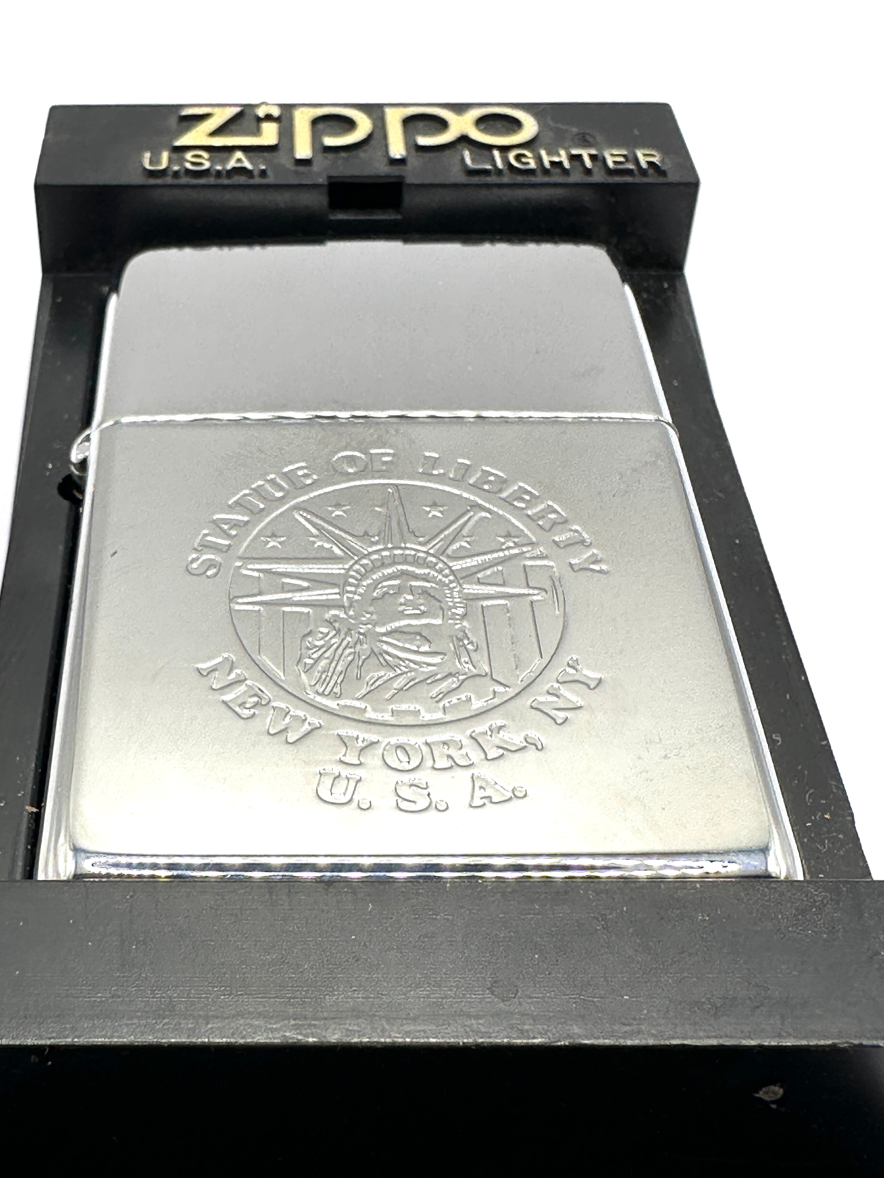 A Zippo Windproof Lighter with Statue of Liberty Motif and Case