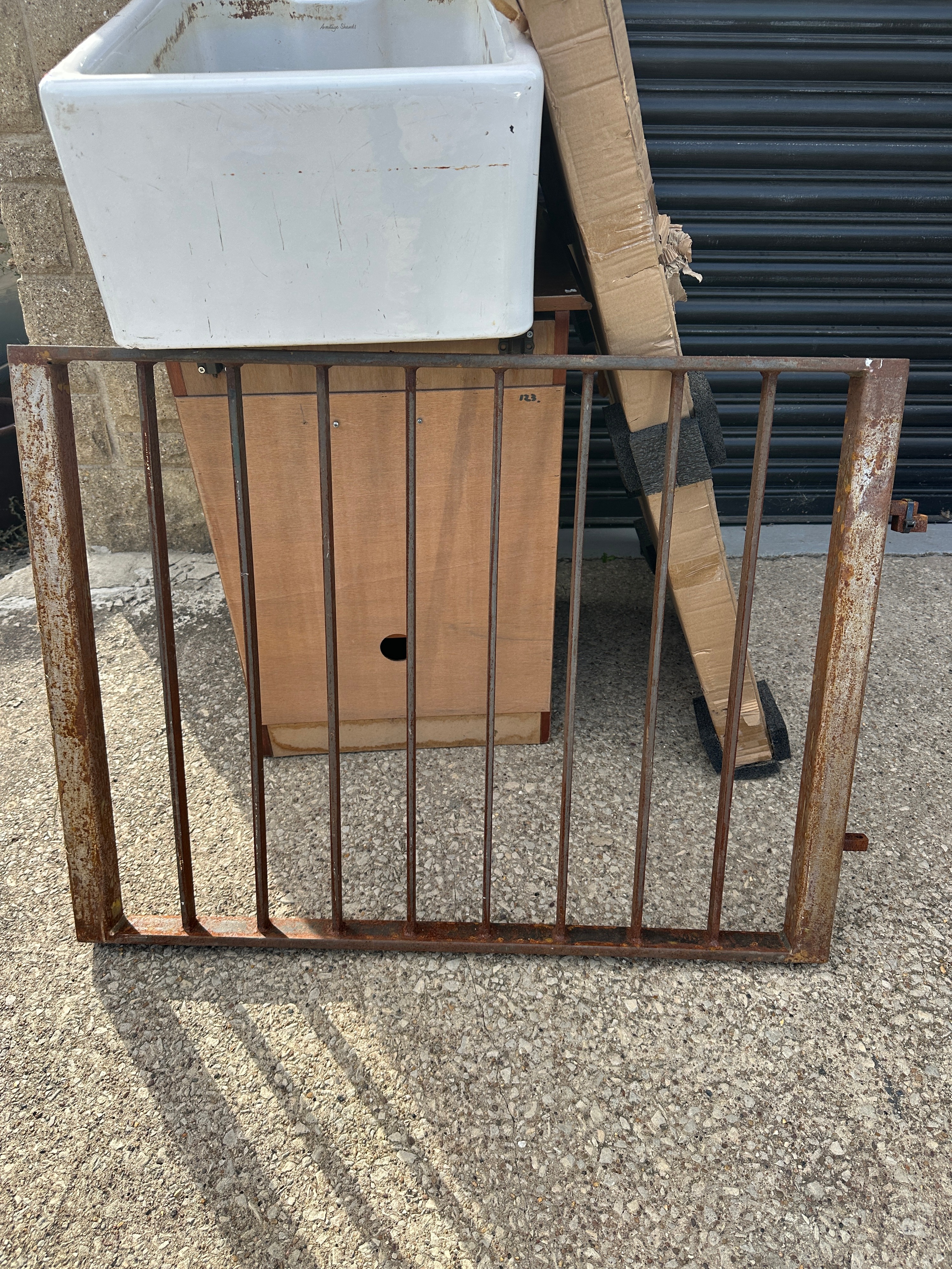 A Metal Window Grille with Hinges and Latch Mechanism