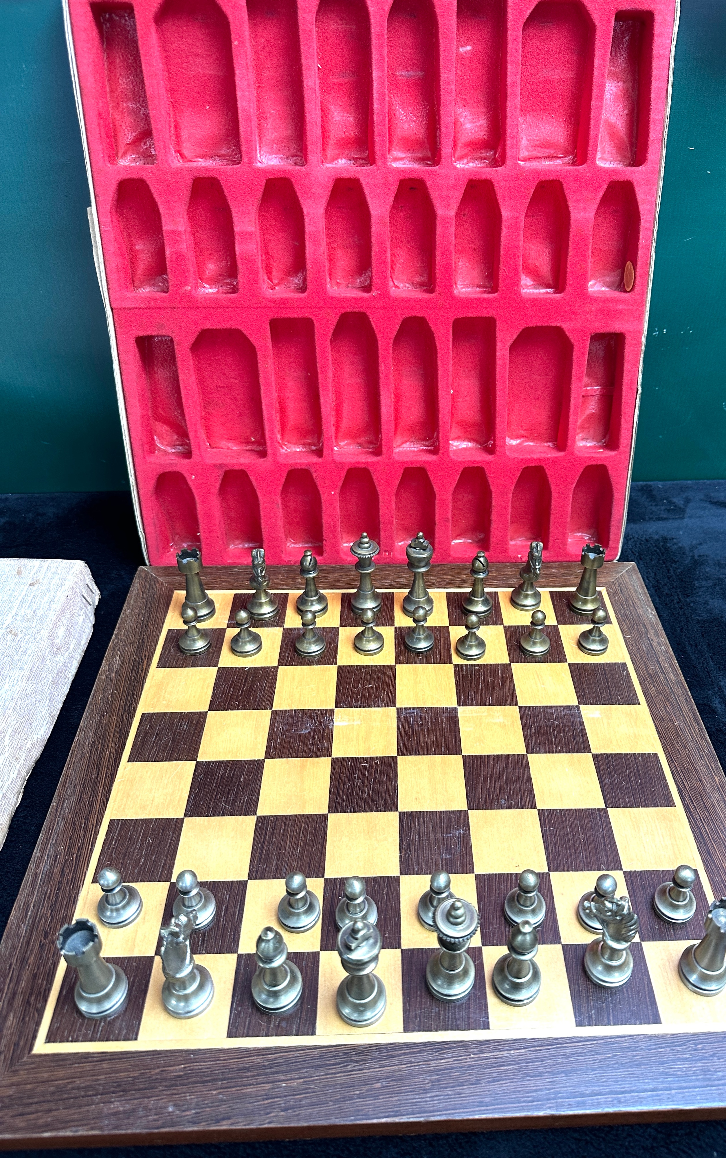 A Metal Chess Set with Fitted Storage Case and Wooden Board