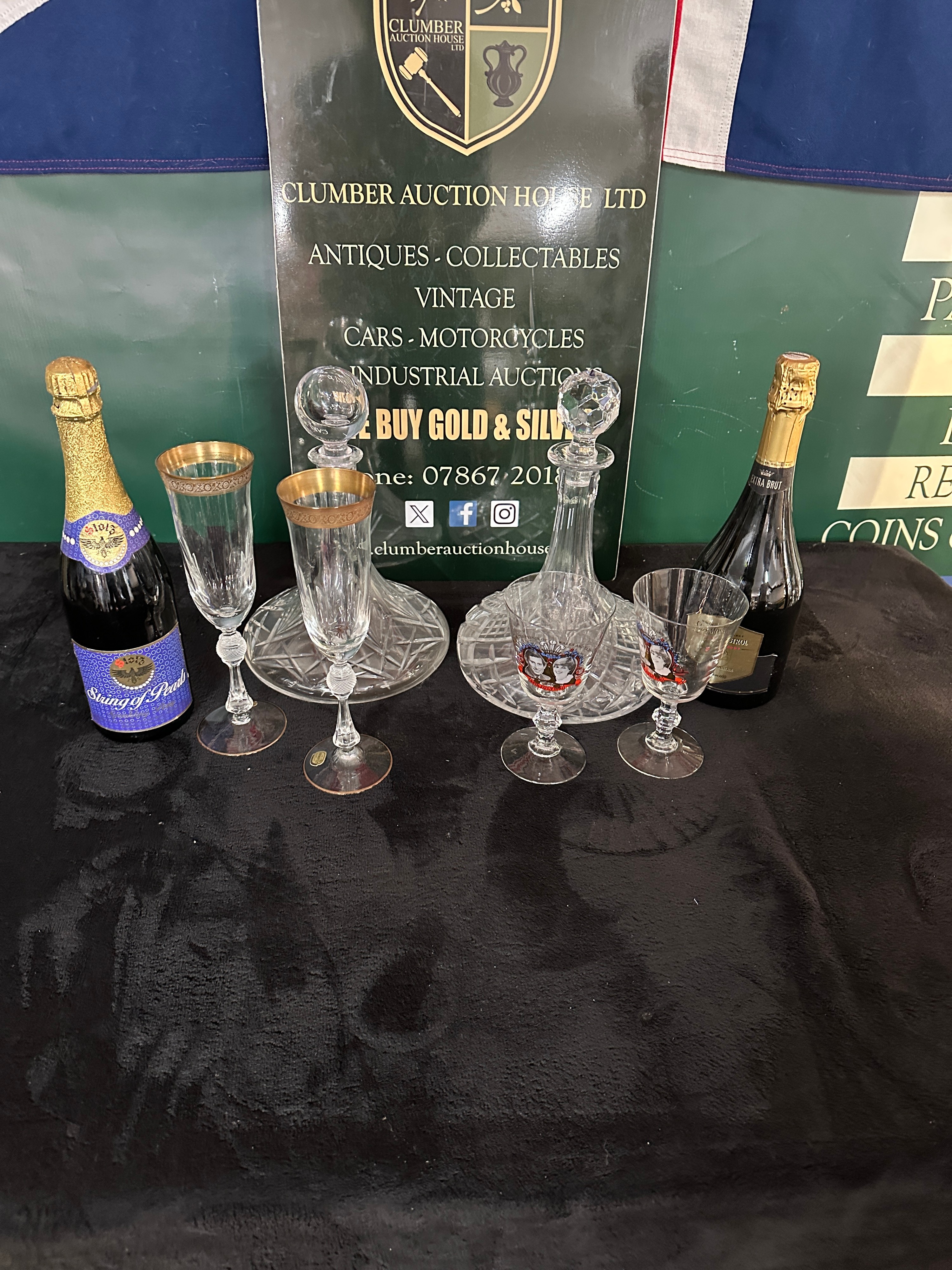 A Collection of Crystal Decanters, Bohemia Glass Flutes, and Sparkling Wine