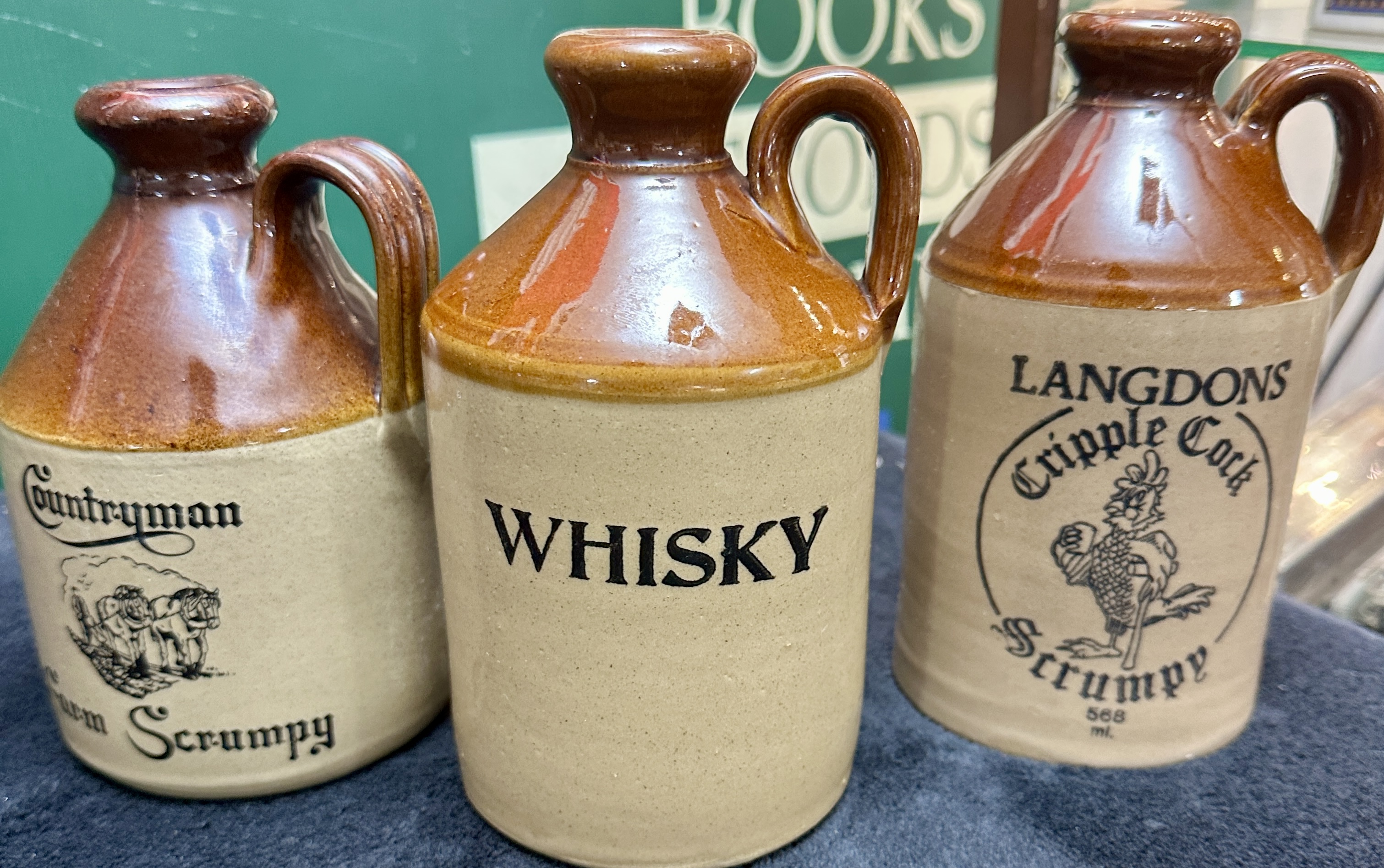 A Trio of English Moira Pottery Stoneware Spirit and Cider Jugs