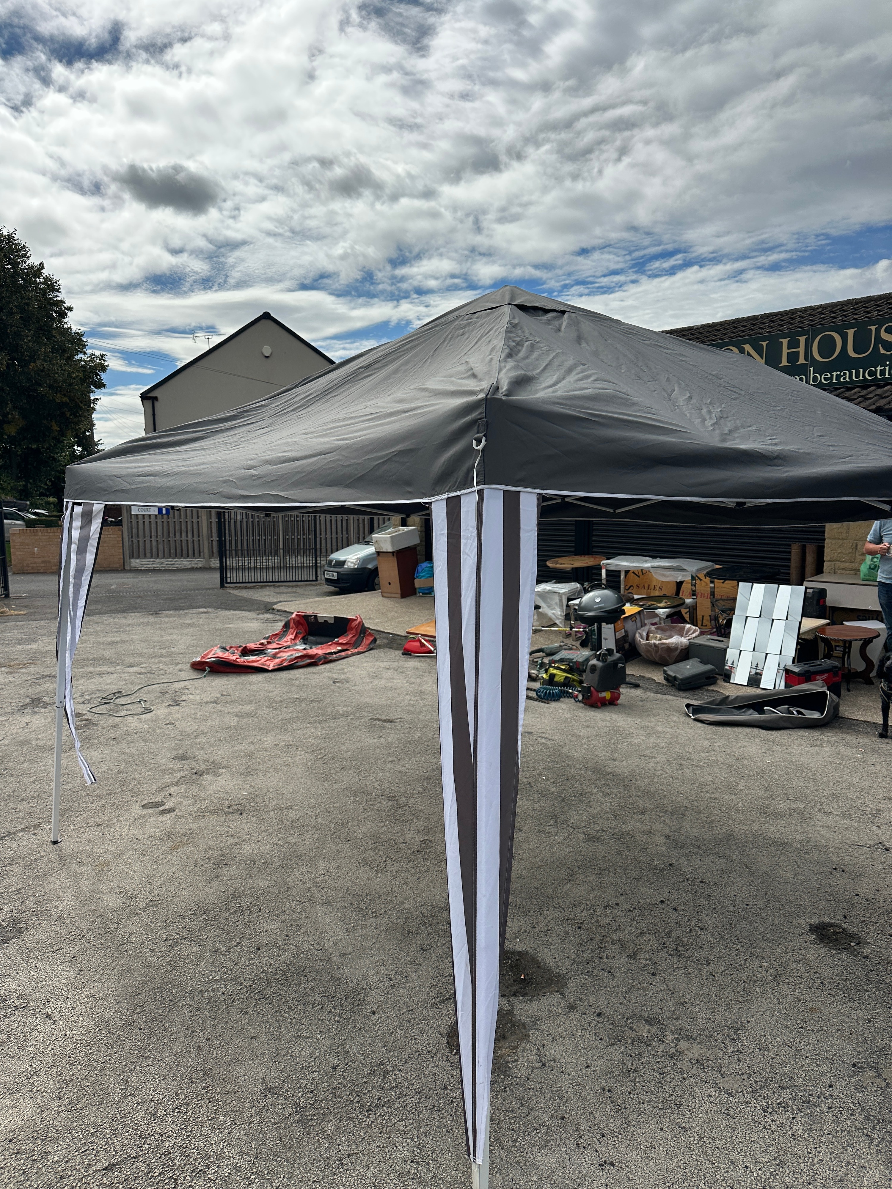 A Portable Pop-up Gazebo with Striped Side Panels and Carrying Bag