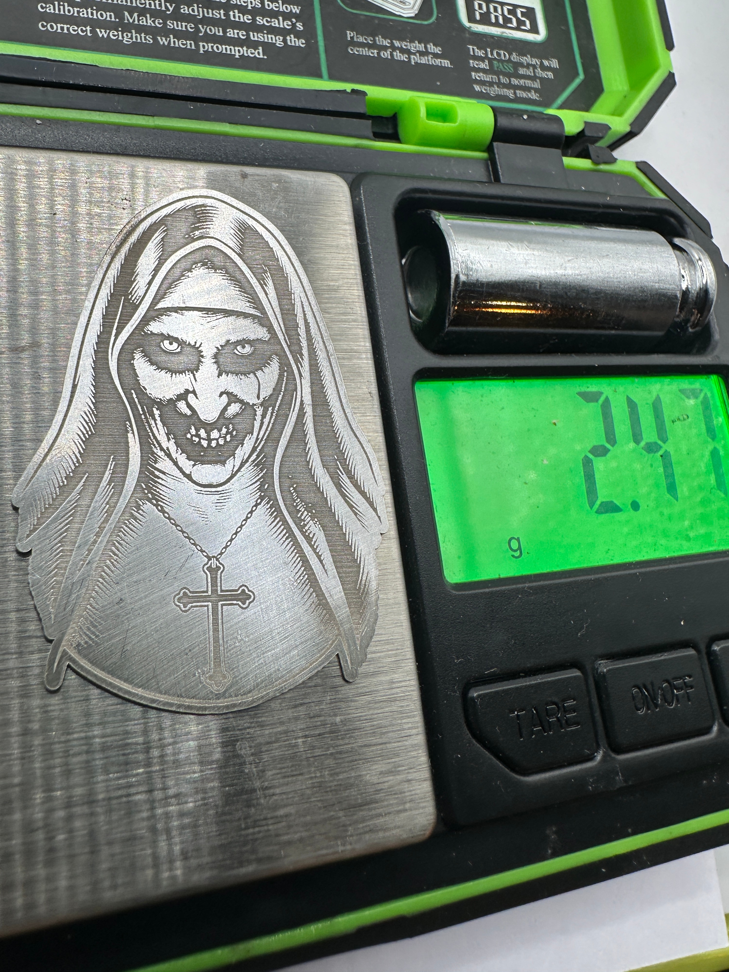 A 999 Silver Plaque Depicting The Nun Valak